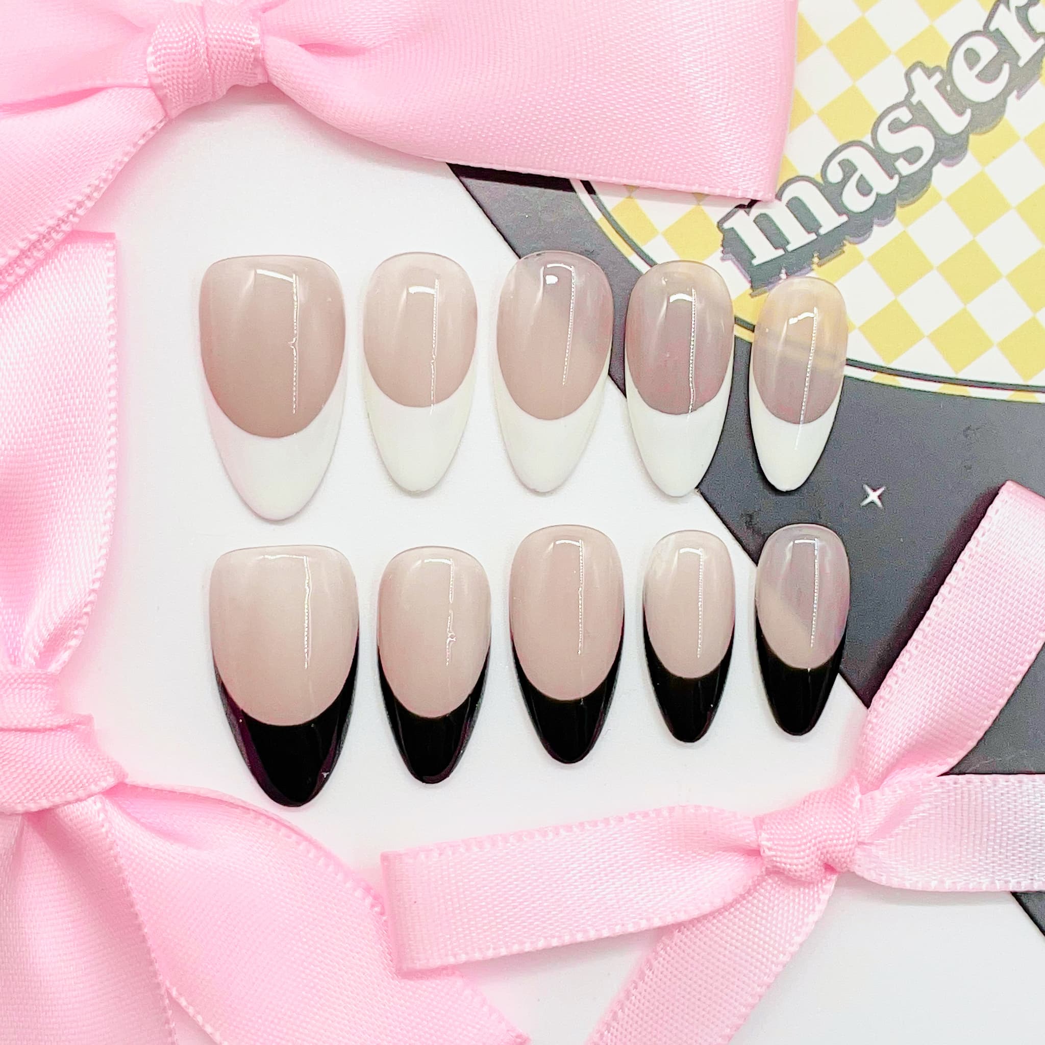 medium length nude almond press on nails with black and white colours french tips