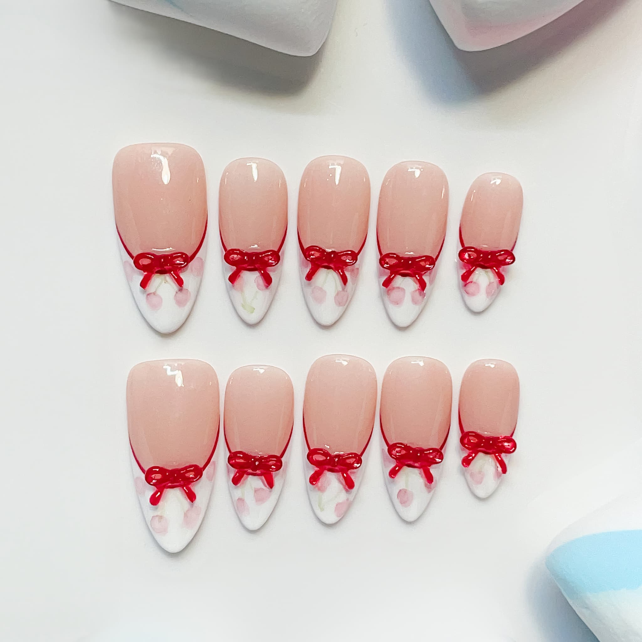 medium length white almond press on nails with cherries and bow design