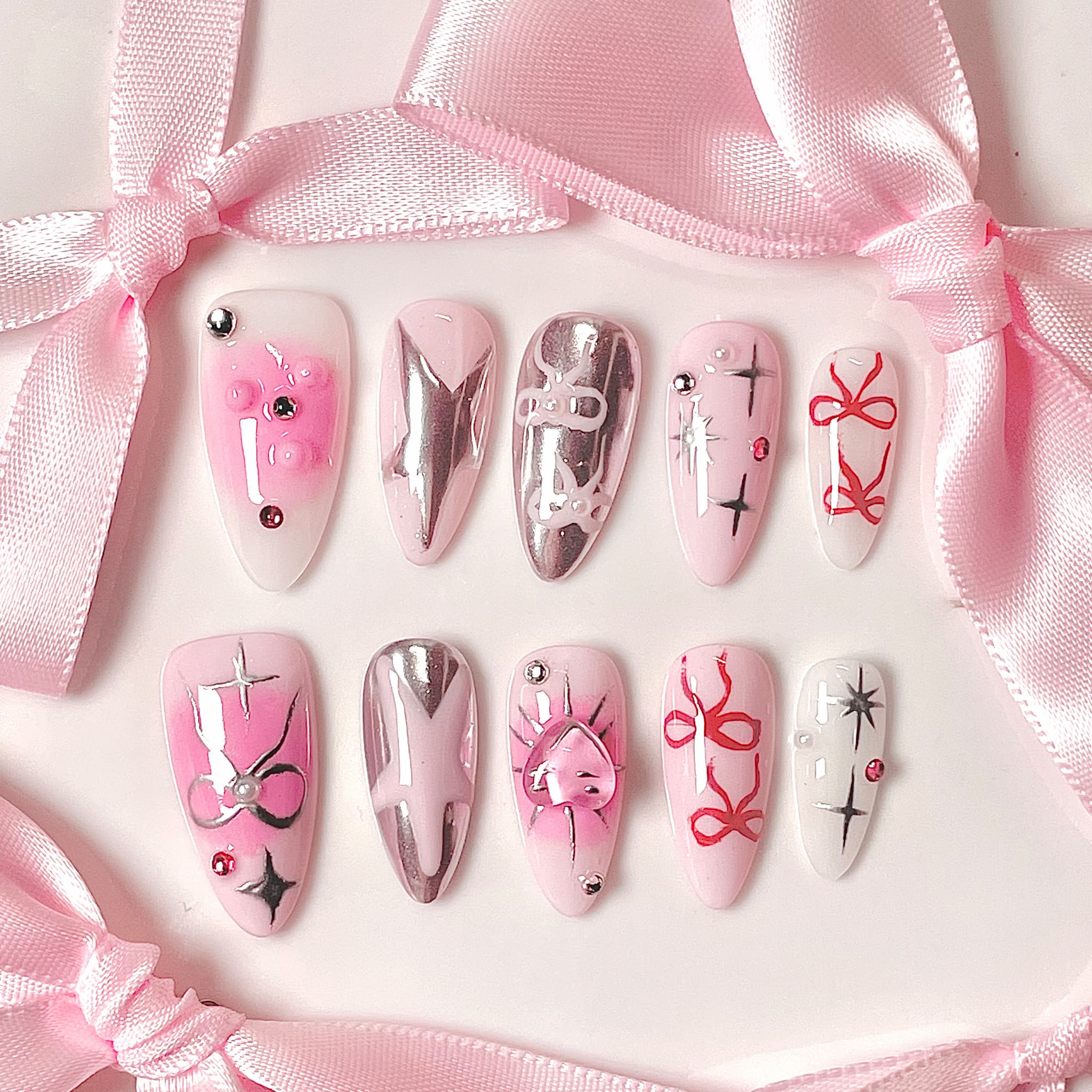 medium length light pink almond press on nails with stars and bows design