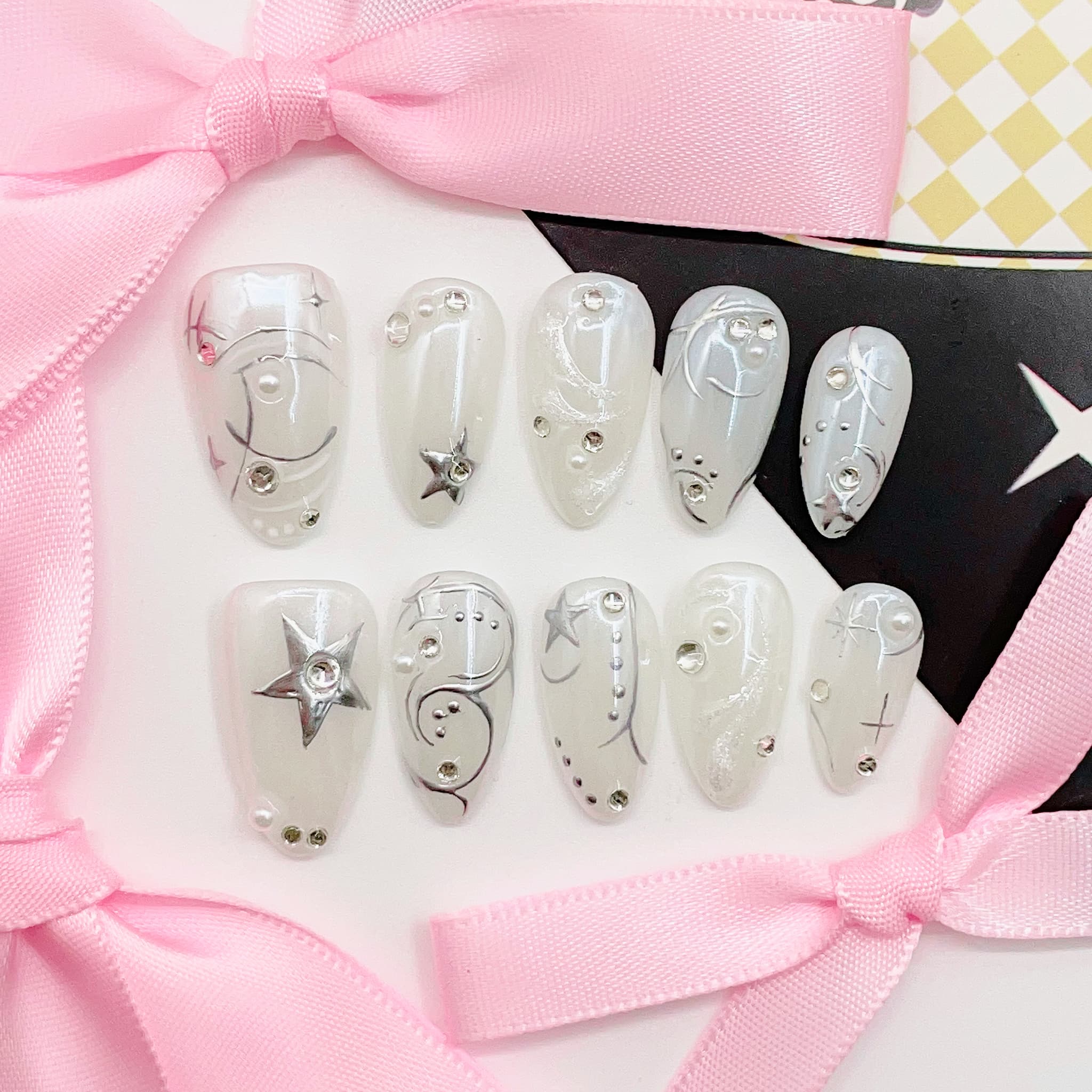 medium length mint cream almond press on nails with celestial designs