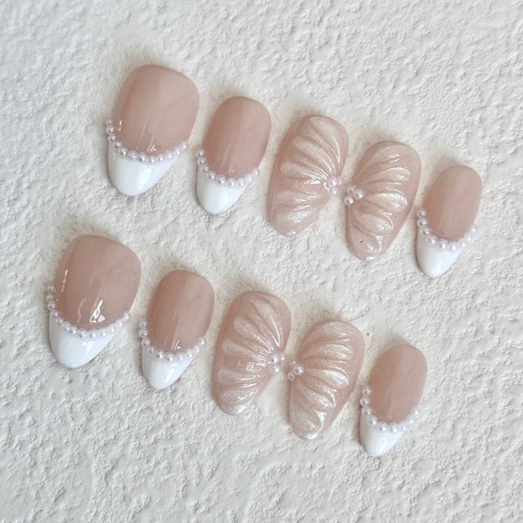 Set of decorative nails with white accents and pearls embellishments 