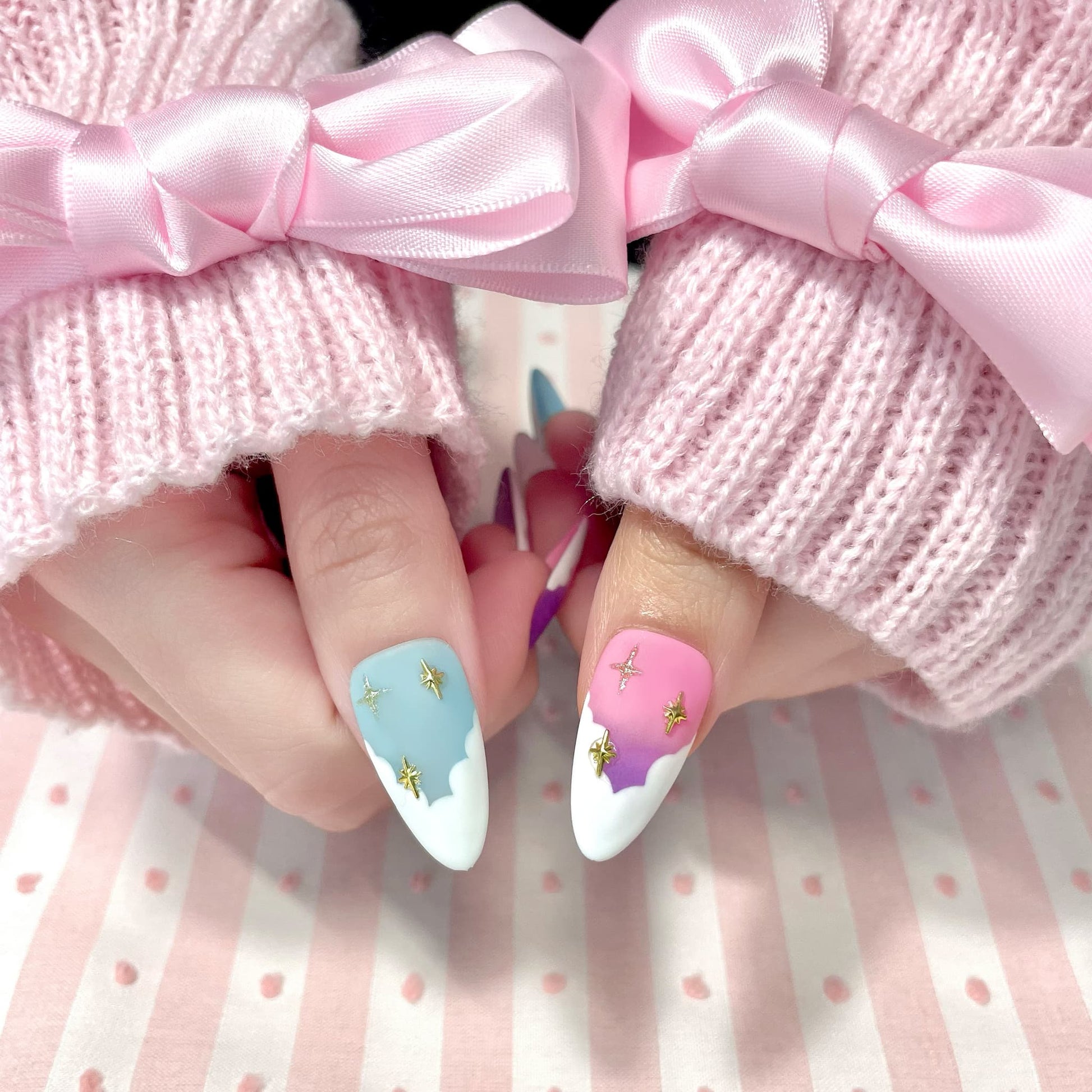 medium length light pink almond press on nails with pastel colour palette and stars