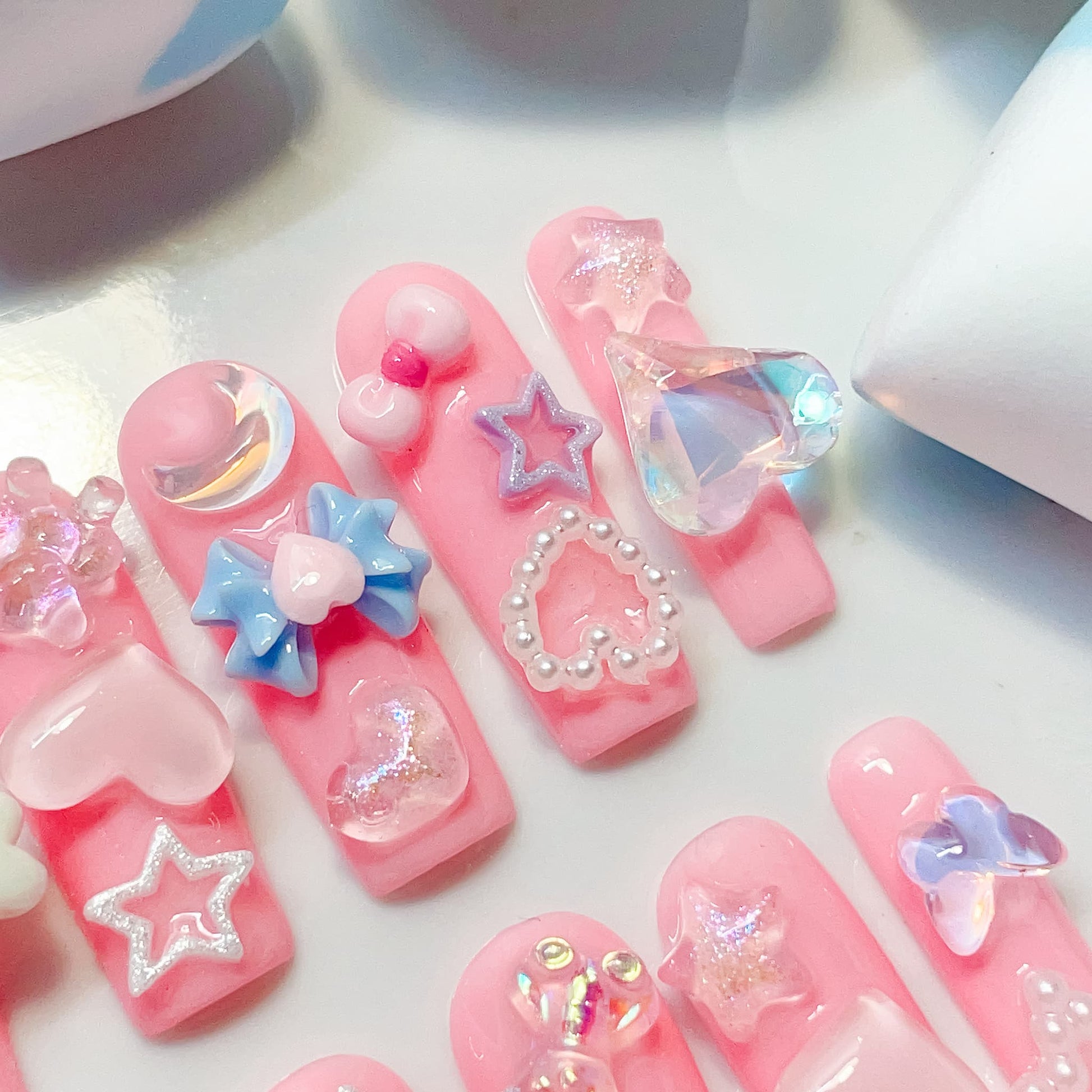 long length light pink square press on nails with star , bows , bear, heart shape and butterfly charm