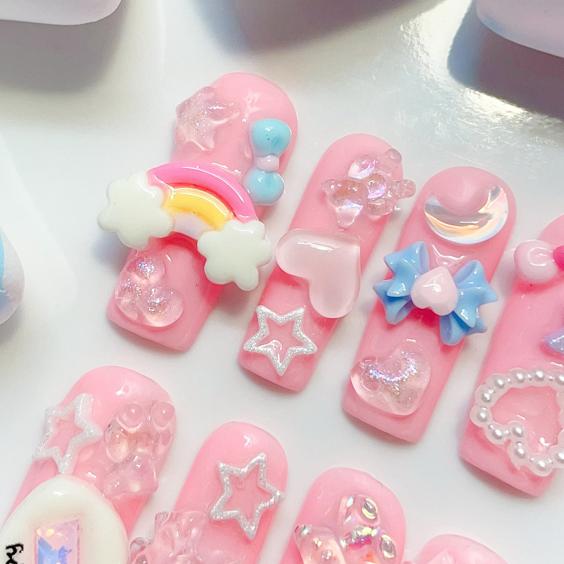 long length light pink square press on nails with star , bows , bear, heart shape and butterfly charm