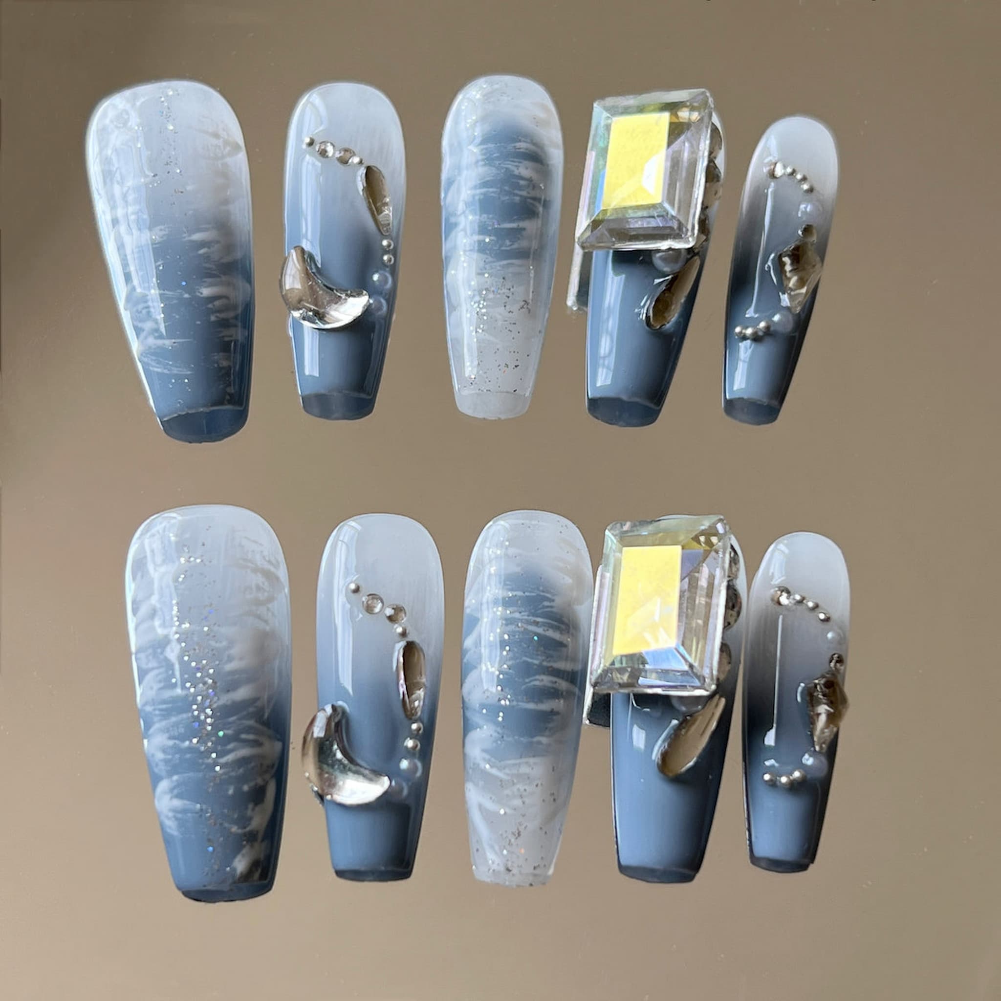 long length dodger blue coffin press on nails with metallic decorations, crescent moon shape and large rectangle gems