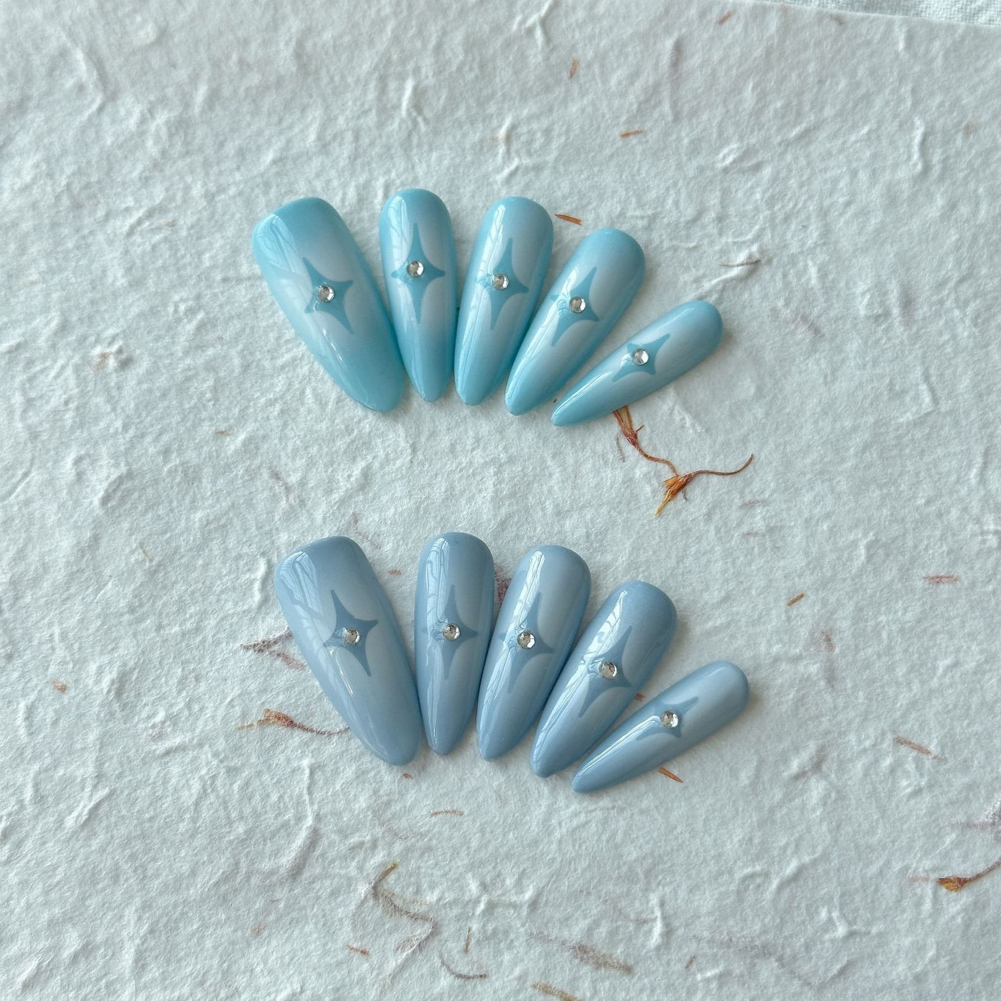 long length powder blue stiletto press on-nails with star symbol