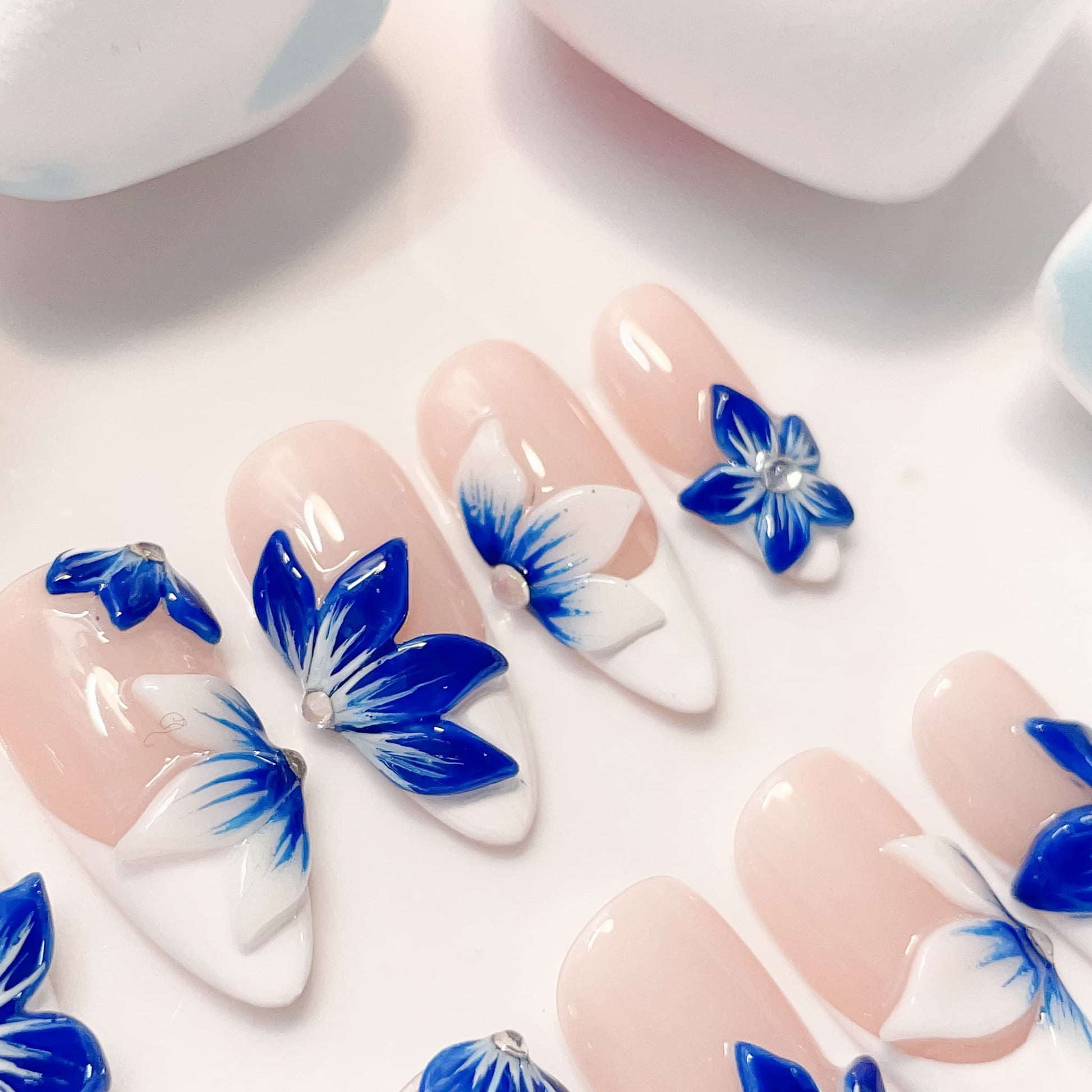 medium length blue almond press on nails with craved flowers design