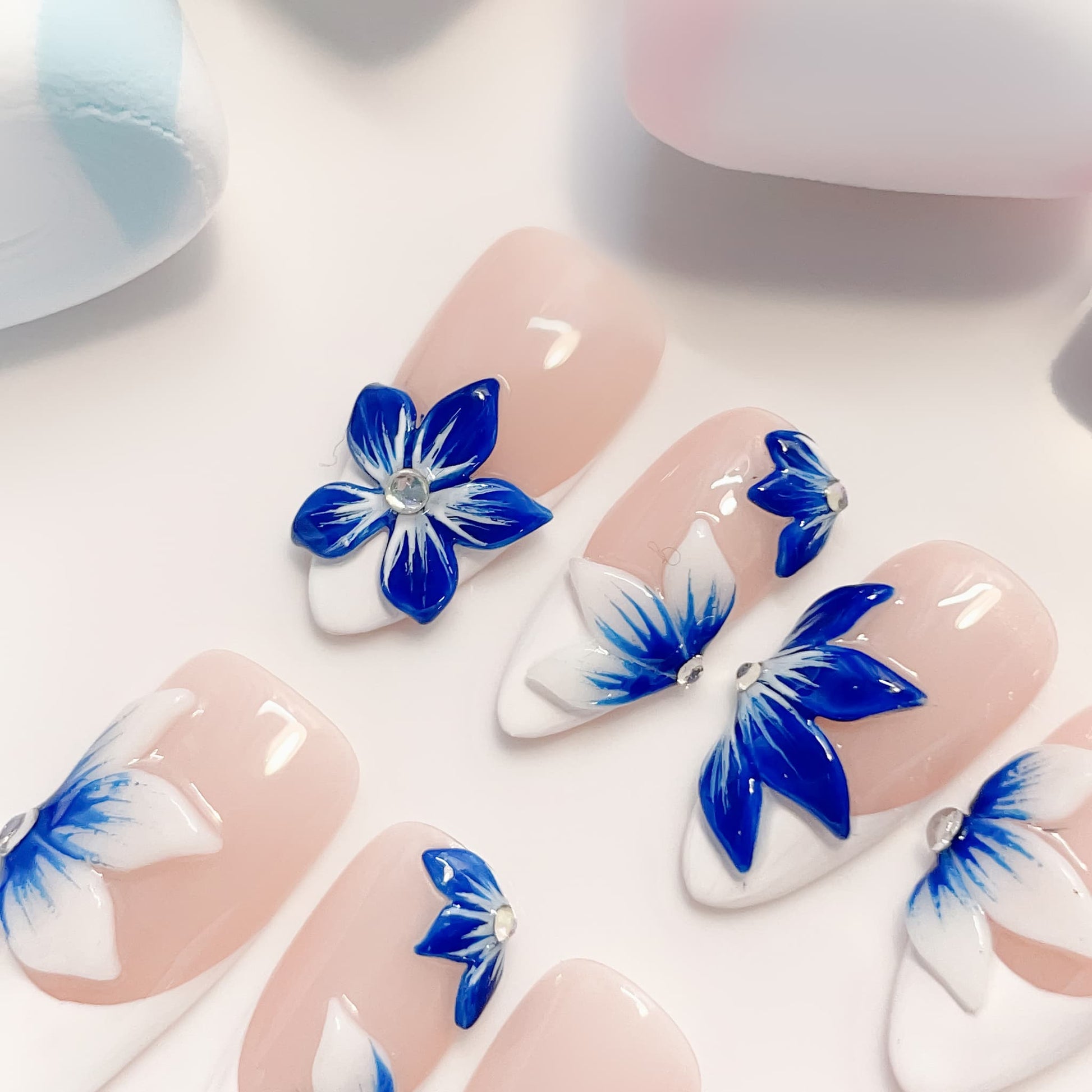 medium length blue almond press on nails with craved flowers design