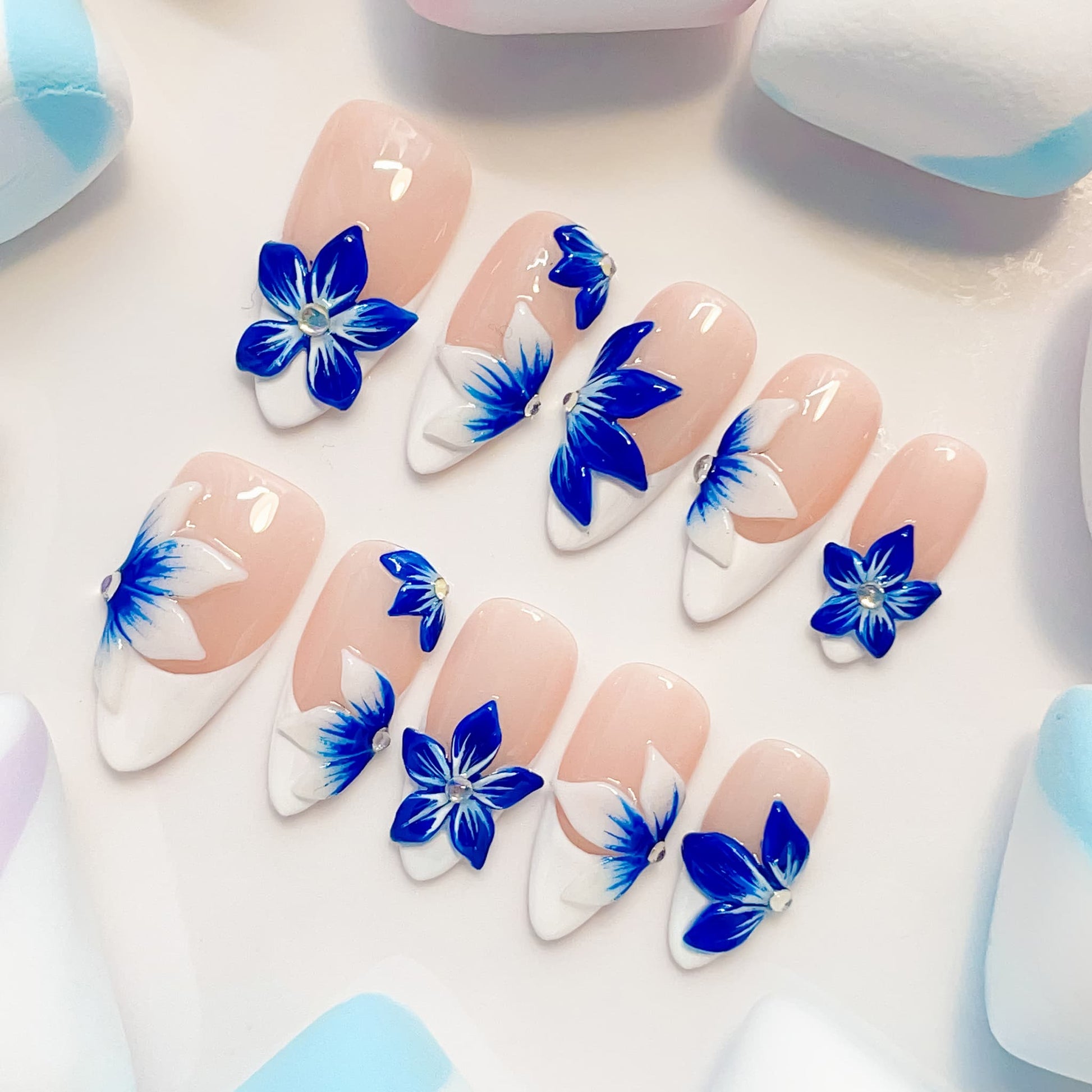 medium length blue almond press on nails with craved flowers design