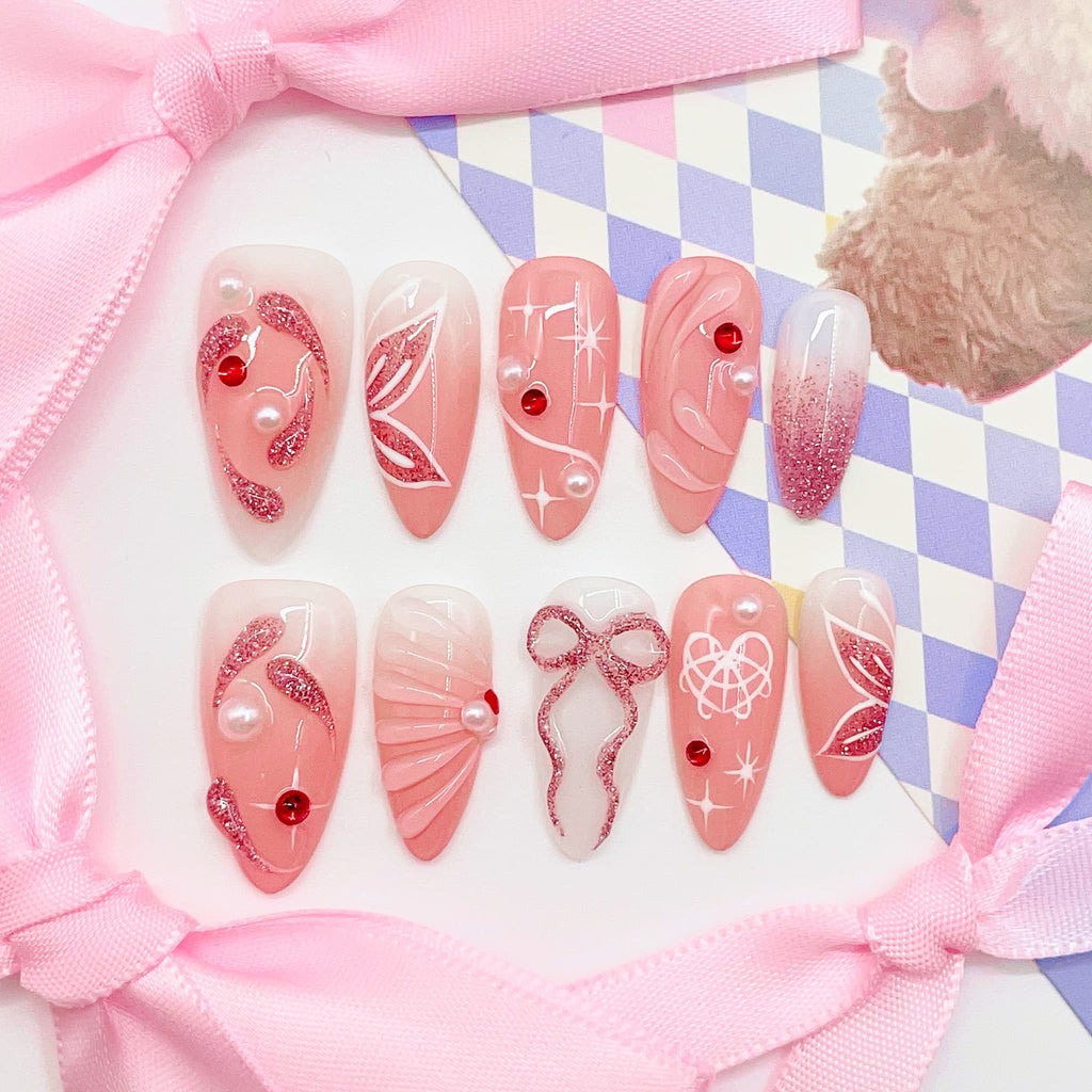 medium length light pink press on nails with butterfly design
