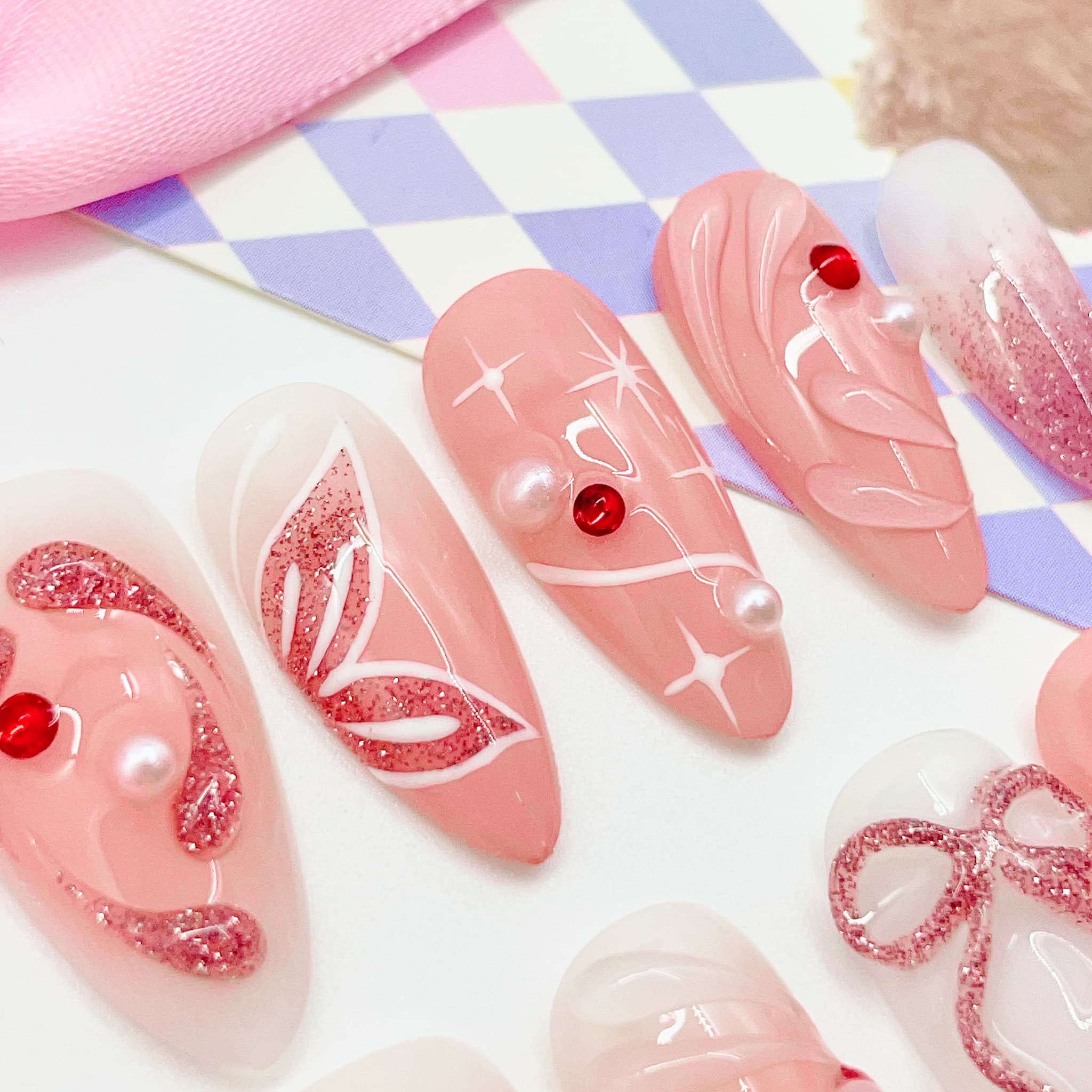 medium length light pink press on nails with butterfly design