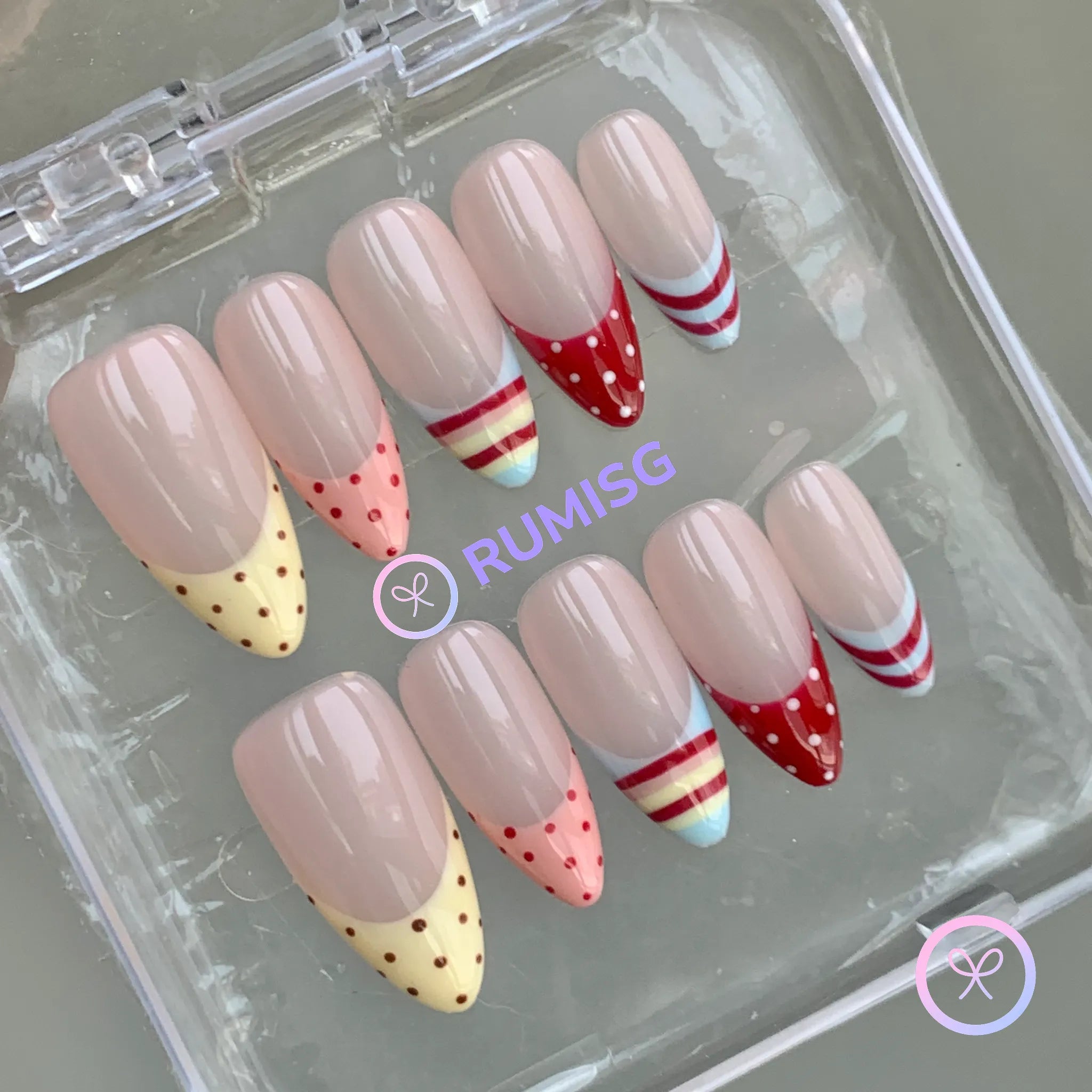 pastelcore nude glossy medium almond press on nails with polka dot and candy stripe french tip