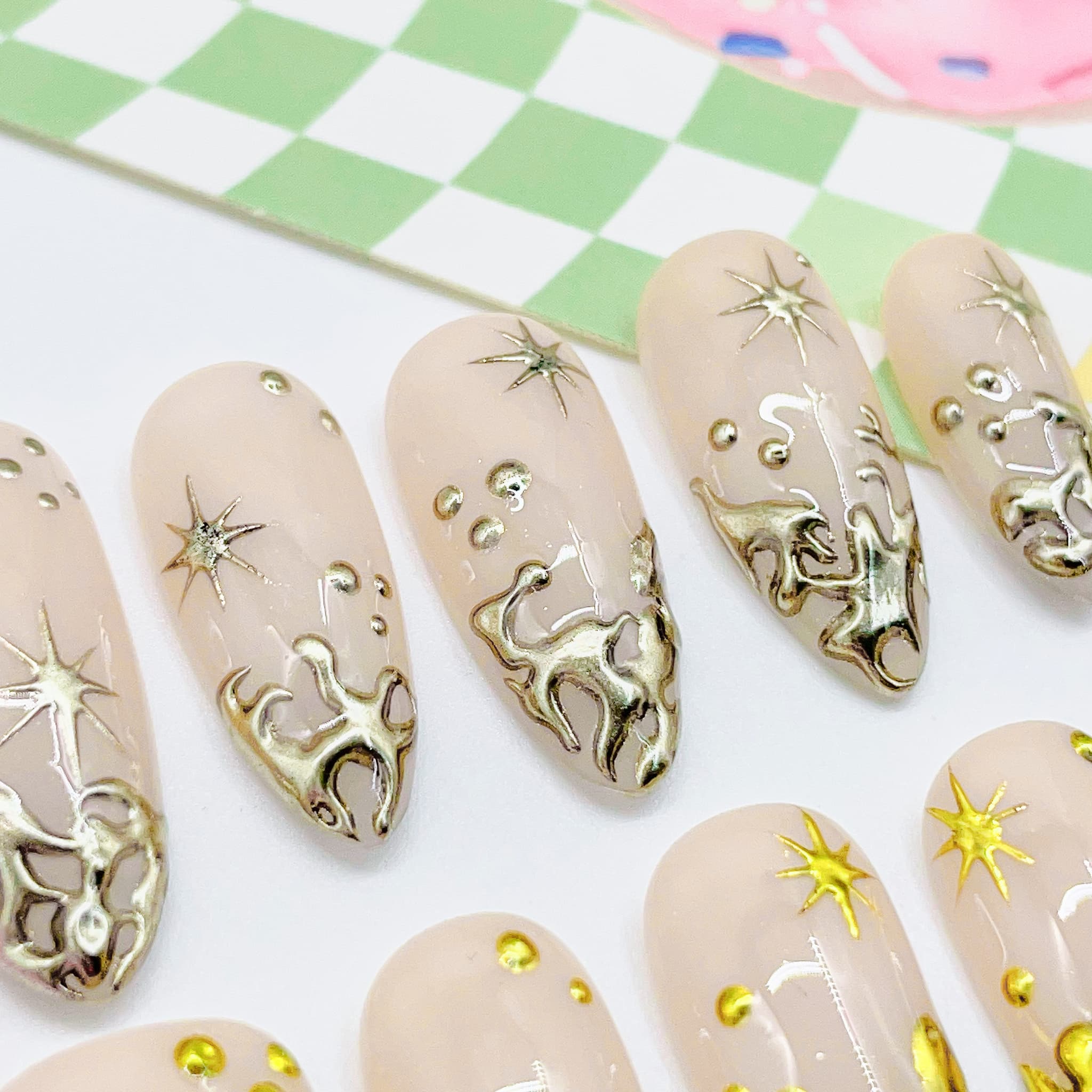 Set of beige nail art designs with gold  decorations
