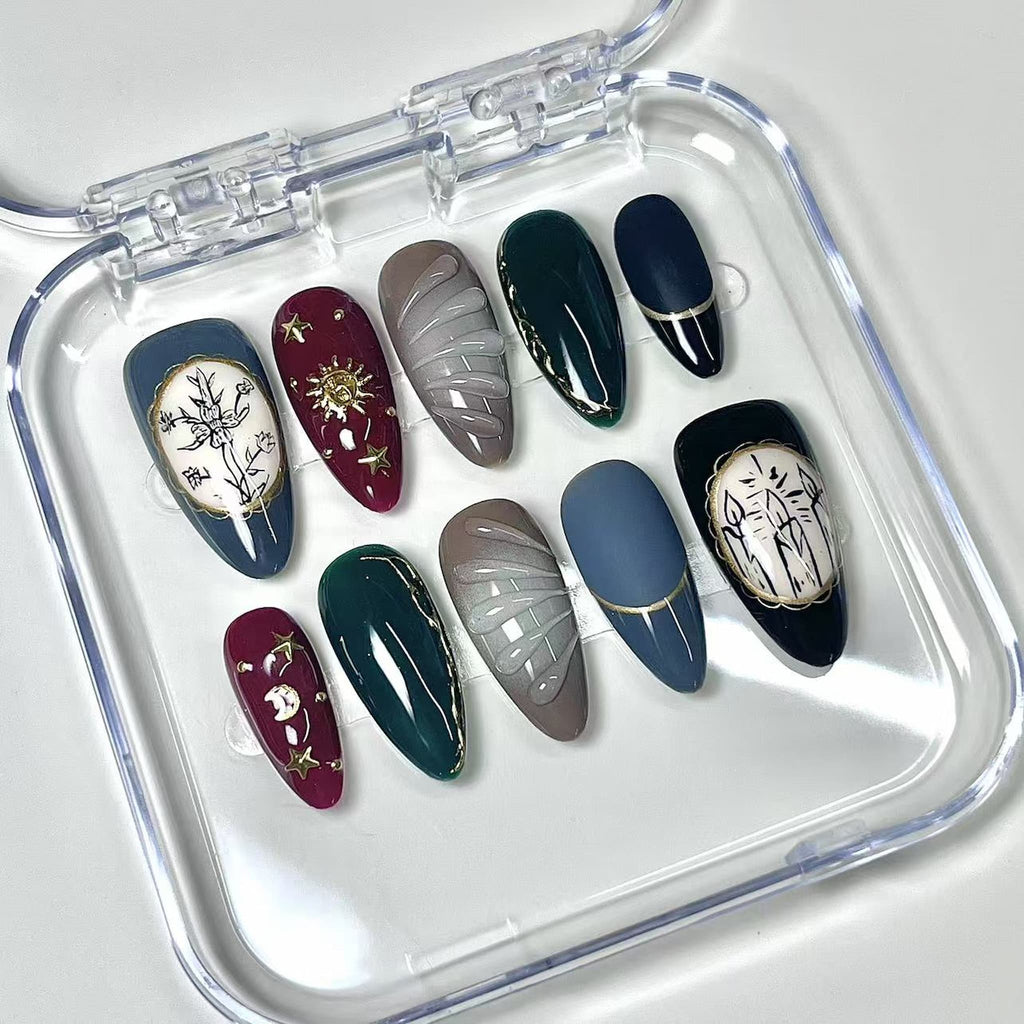 medium length maroon almond press on nails with sun and cresent moon design