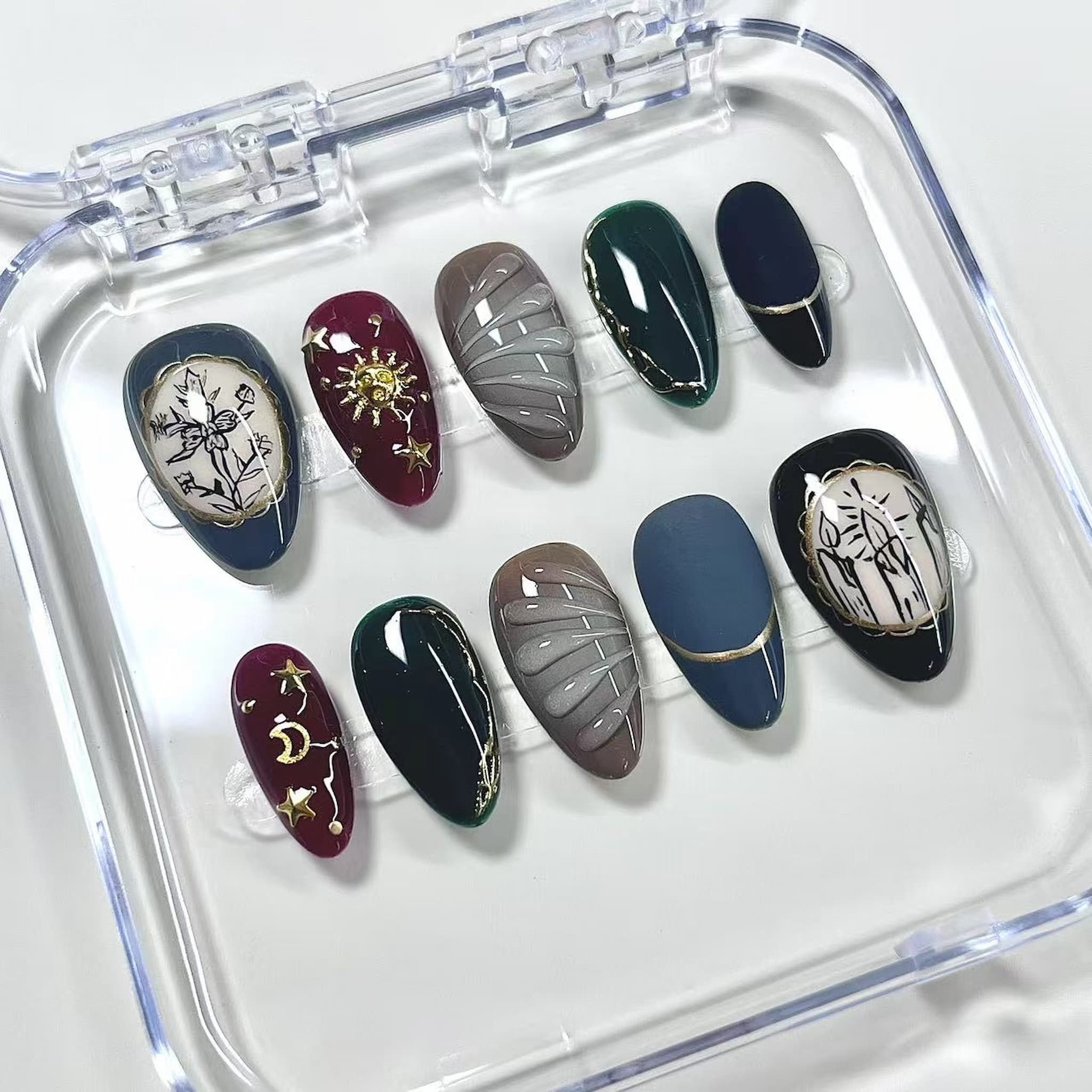 short length maroon almond press on nails with sun and cresent moon design