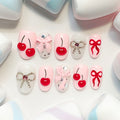 light pink short length oval press on nails with cherries and bows