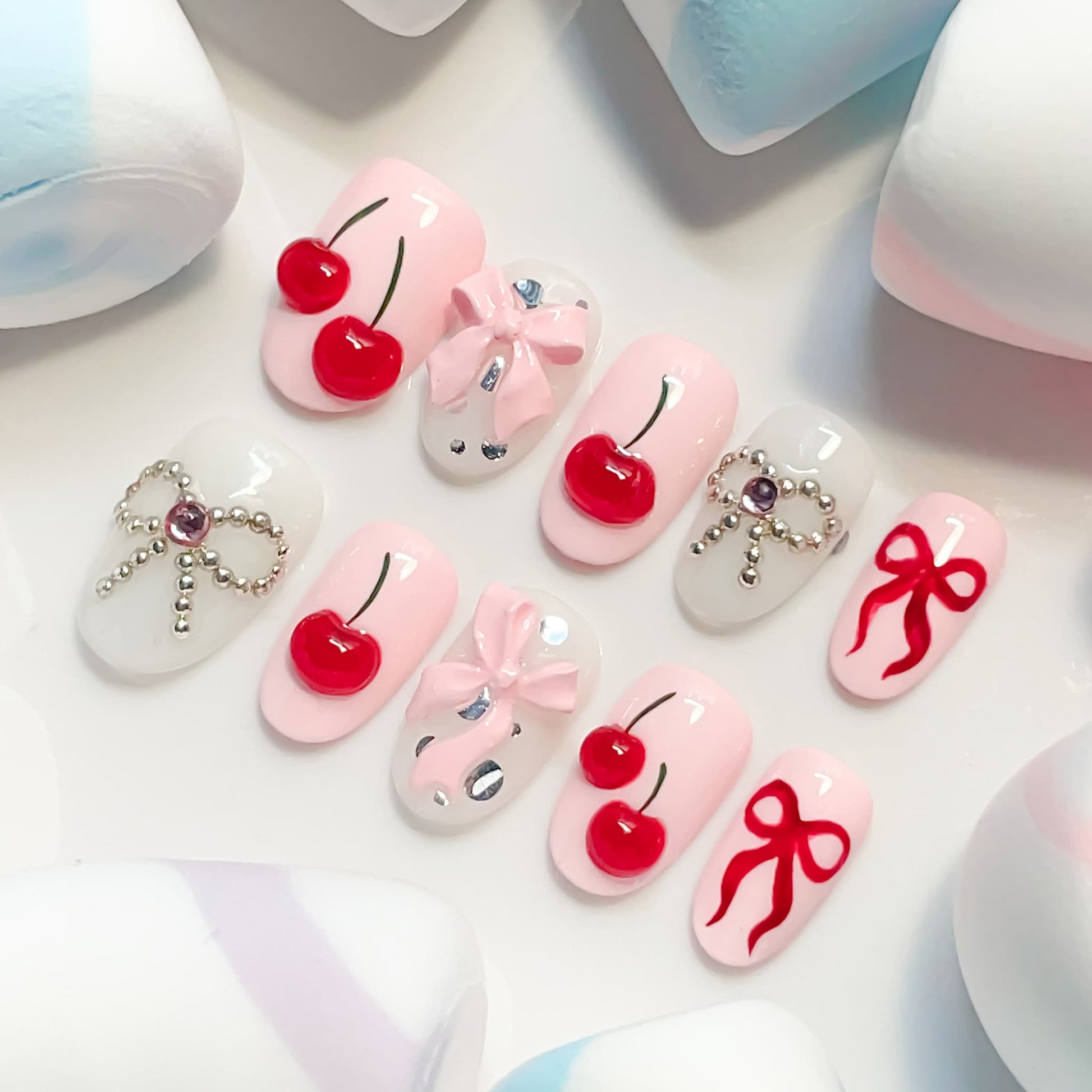 light pink short length oval press on nails with cherries and bows