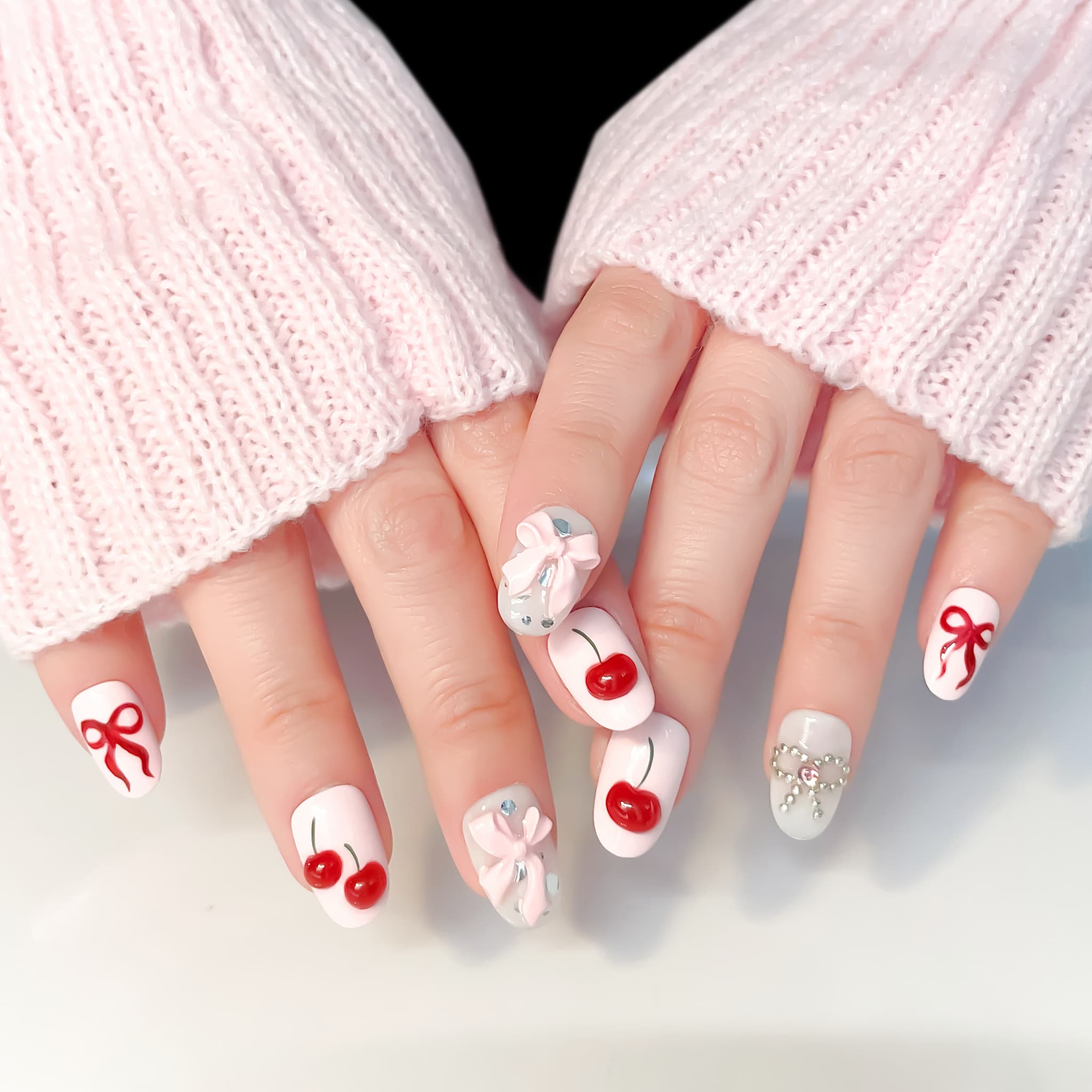 light pink short length oval press on nails with cherries and bows