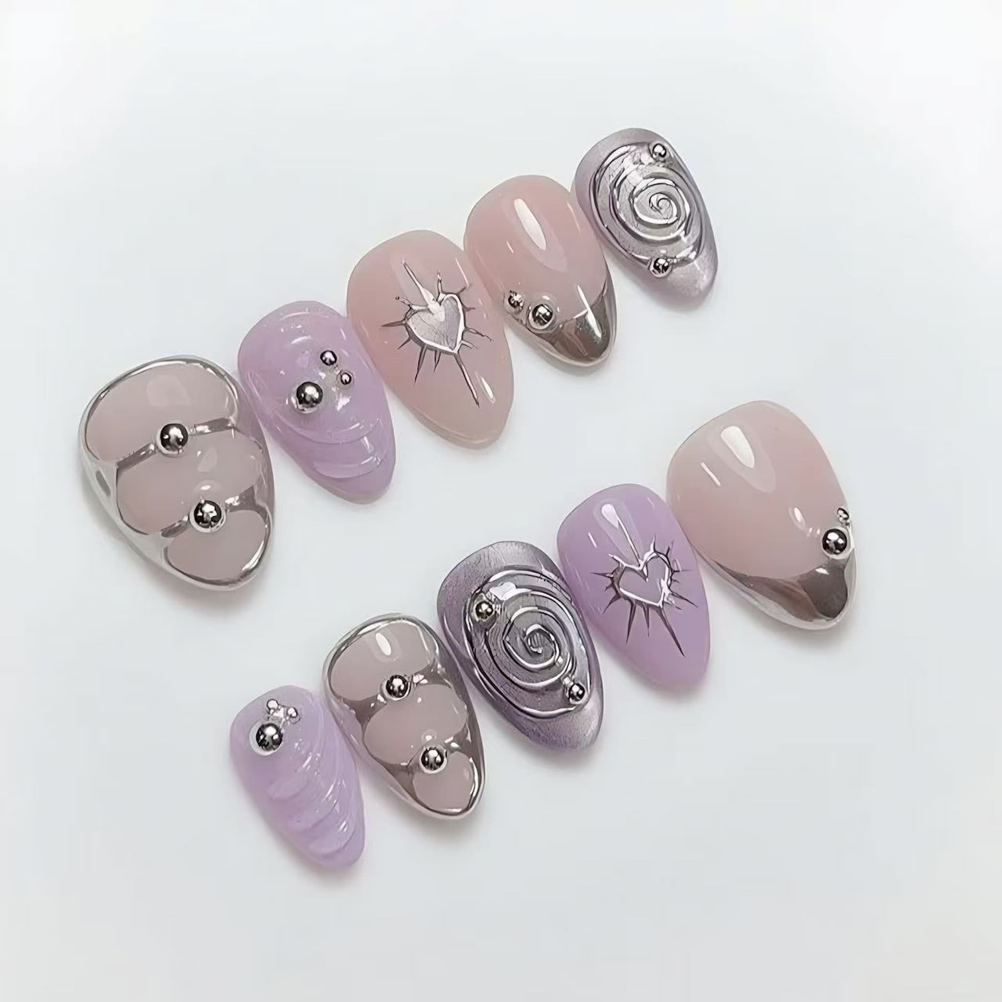 y2k purple chrome short almond press on nails with spiral motifs and chrome hearts