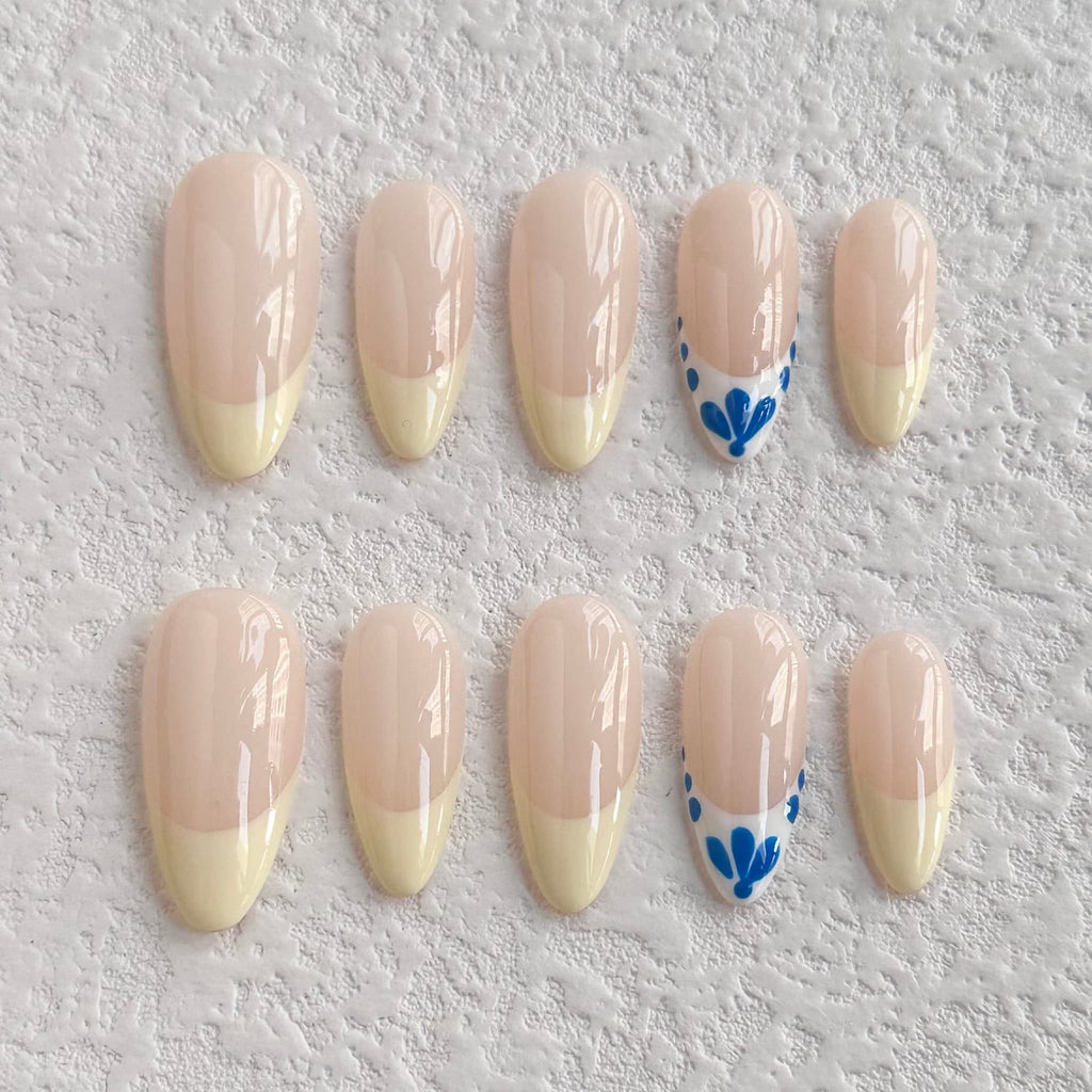 medium length nude almond press on nails with french tips design