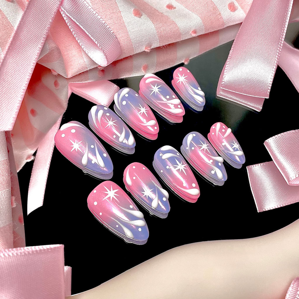 medium length light pink almond press on nails with stars and swirl design