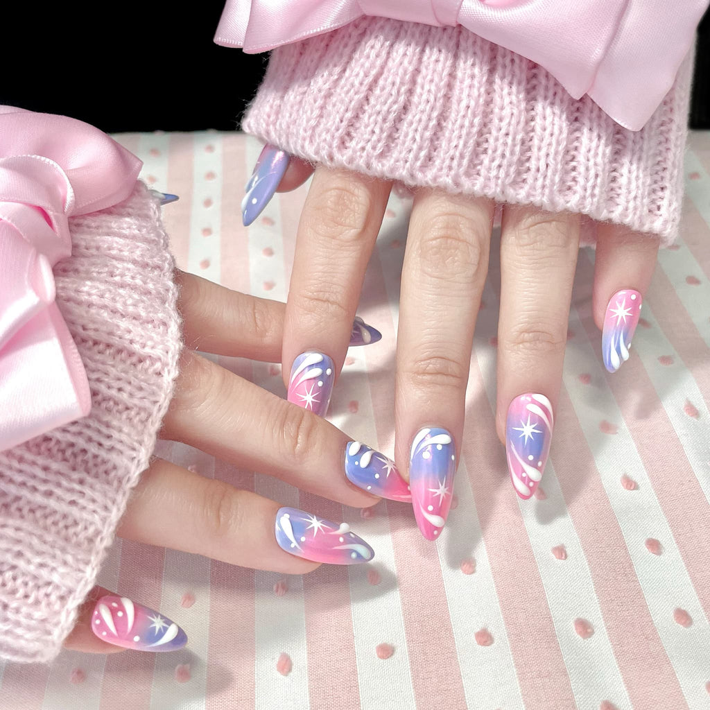 medium length light pink almond press on nails with stars and swirl design
