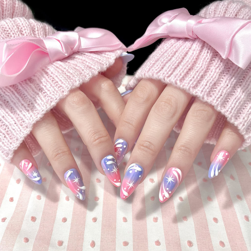 medium length light pink almond press on nails with stars and swirl design
