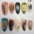 medium length saddle brown press on nails with apple and marble designs