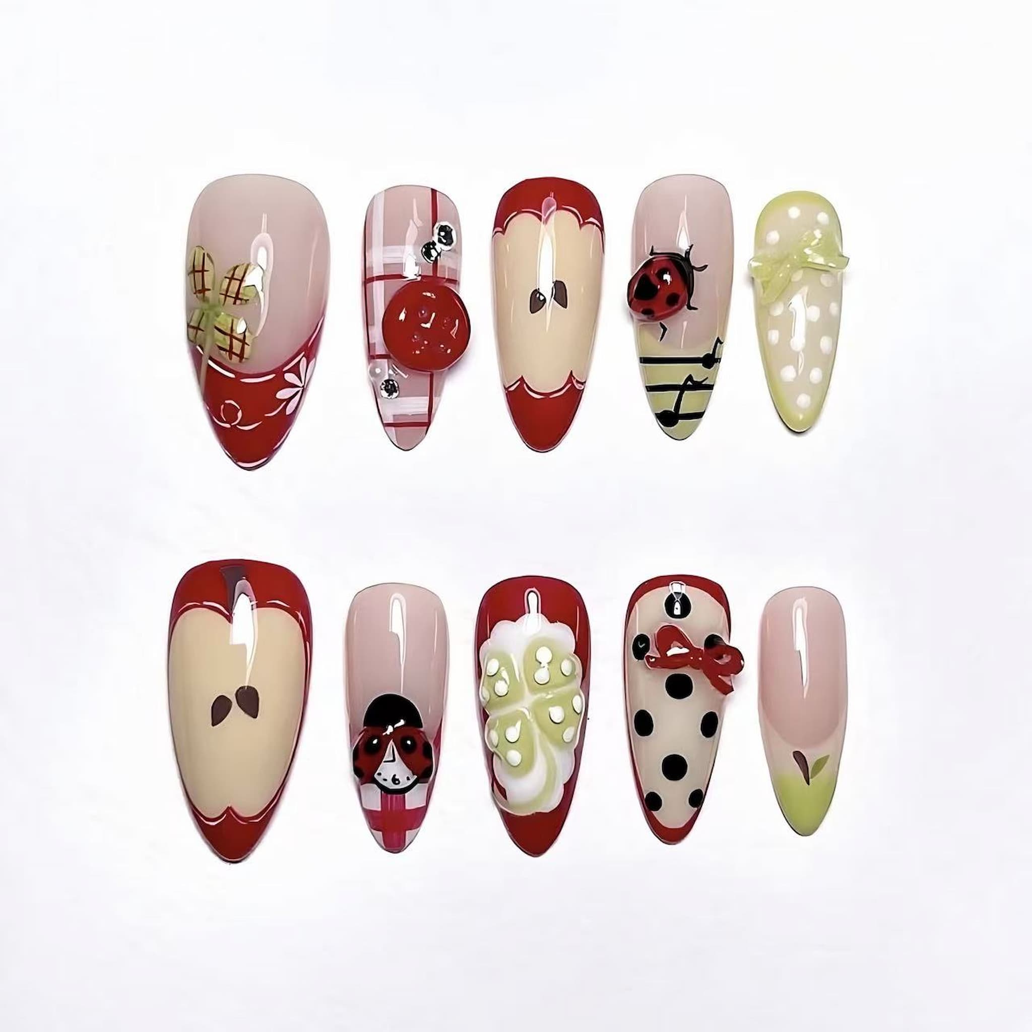 medium length fire brick almond press on nails with ladybug , cotton and apple design