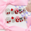 Set of decorative nail art designs with keys, hearts, and bows