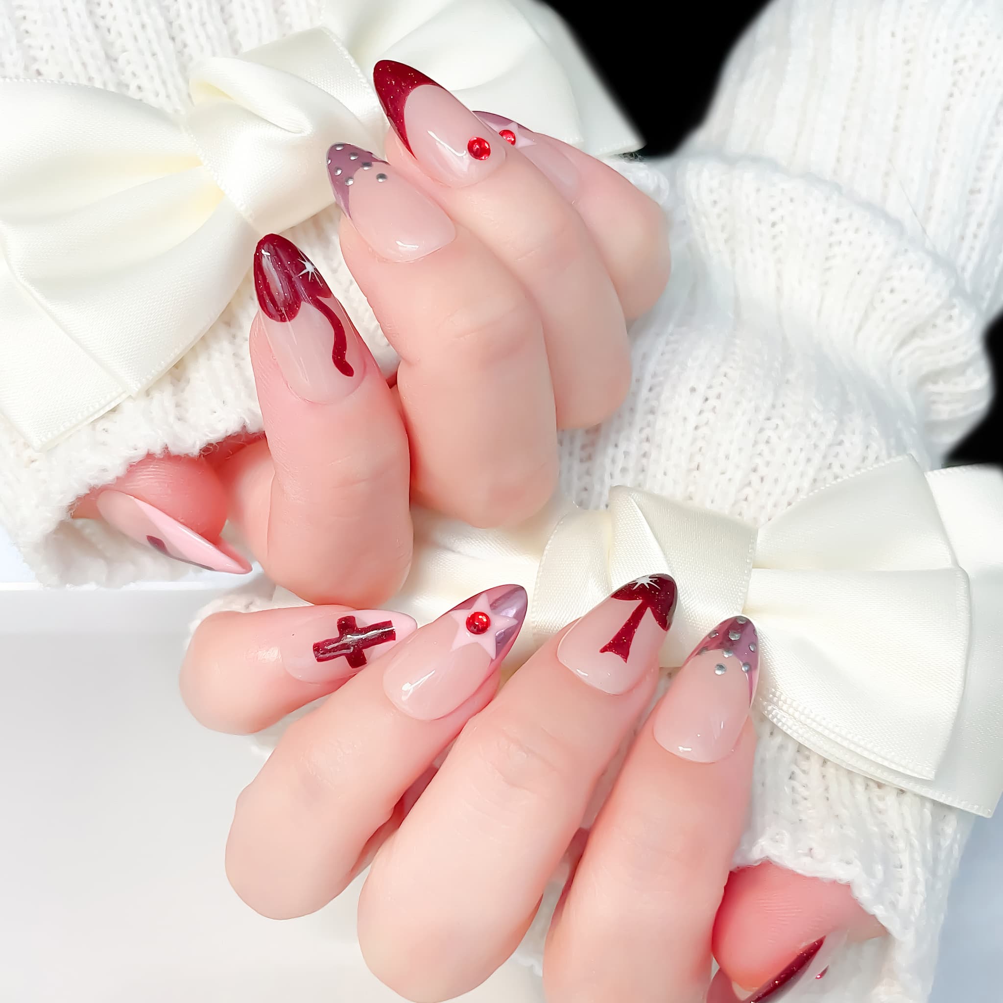 medium length red almond press on nails with crusader design