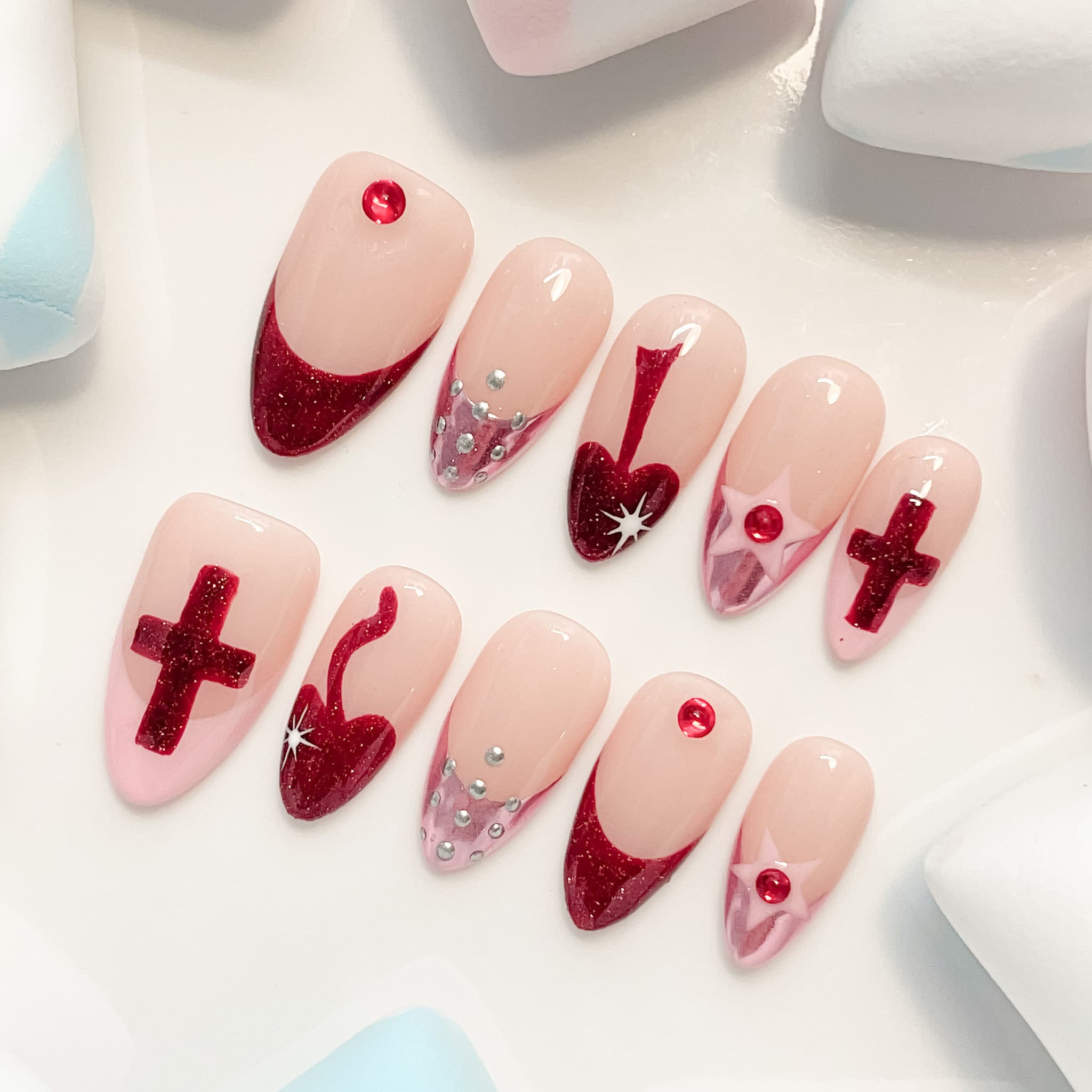 medium length red almond press on nails with crusader design