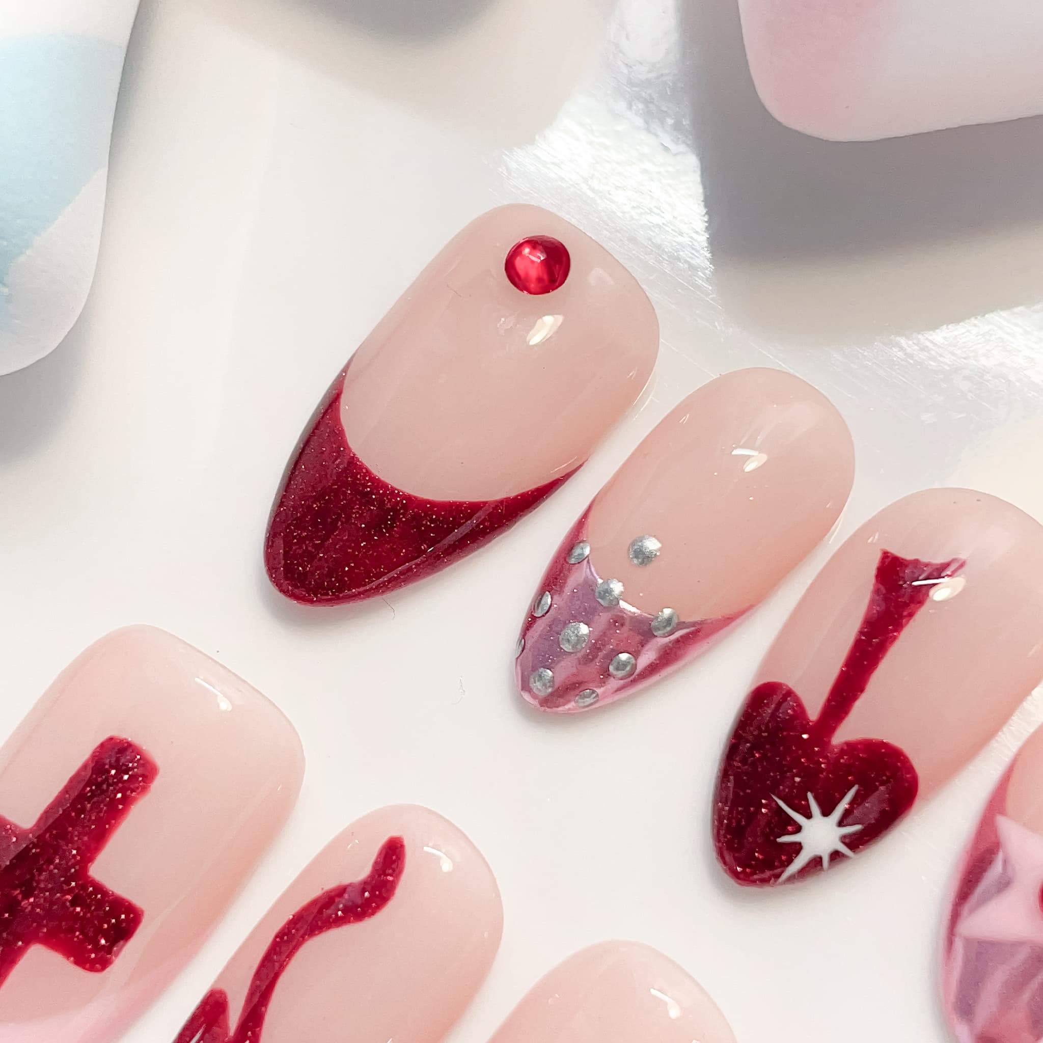 medium length red almond press on nails with crusader design