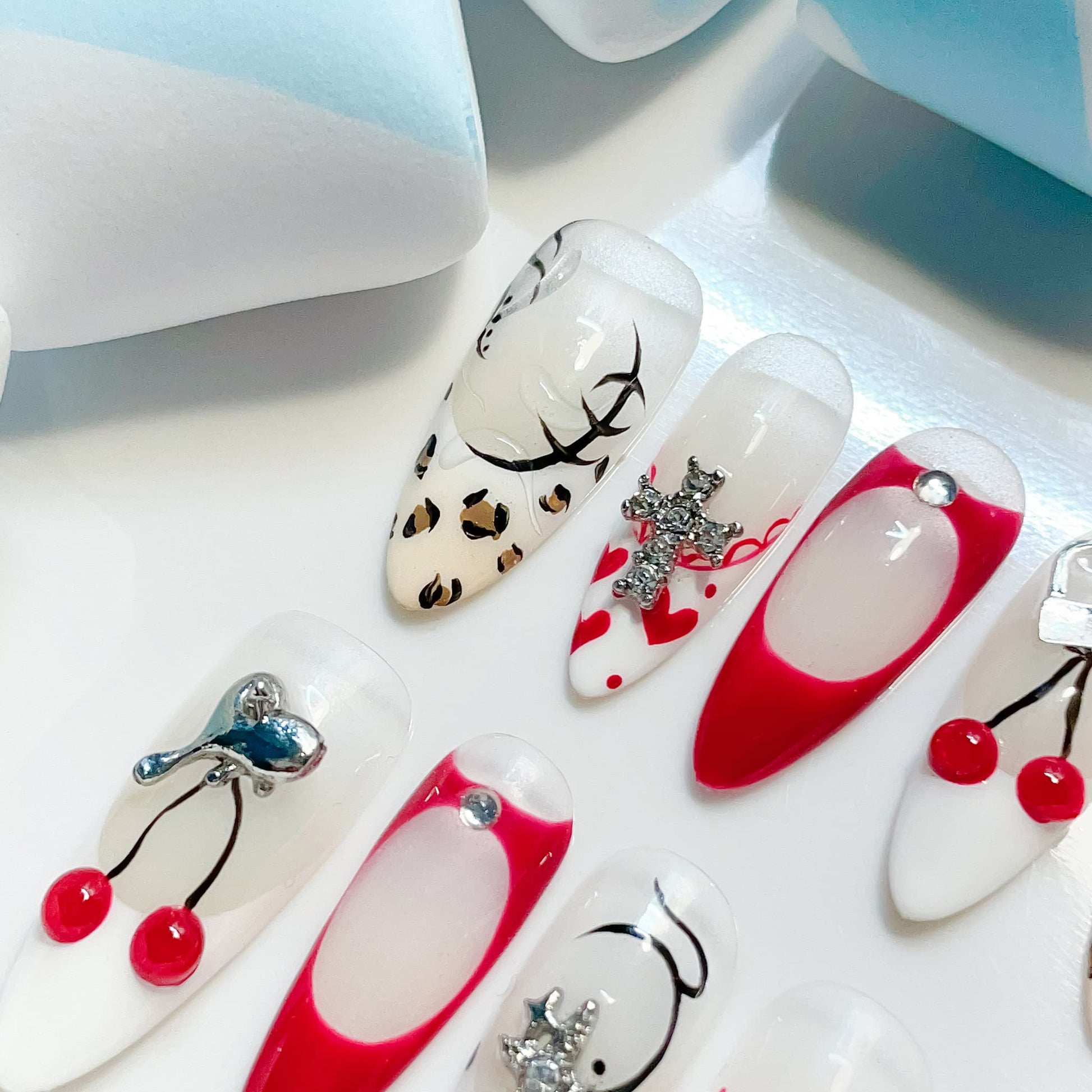 long length red almond press on nails with cherry and animal print design