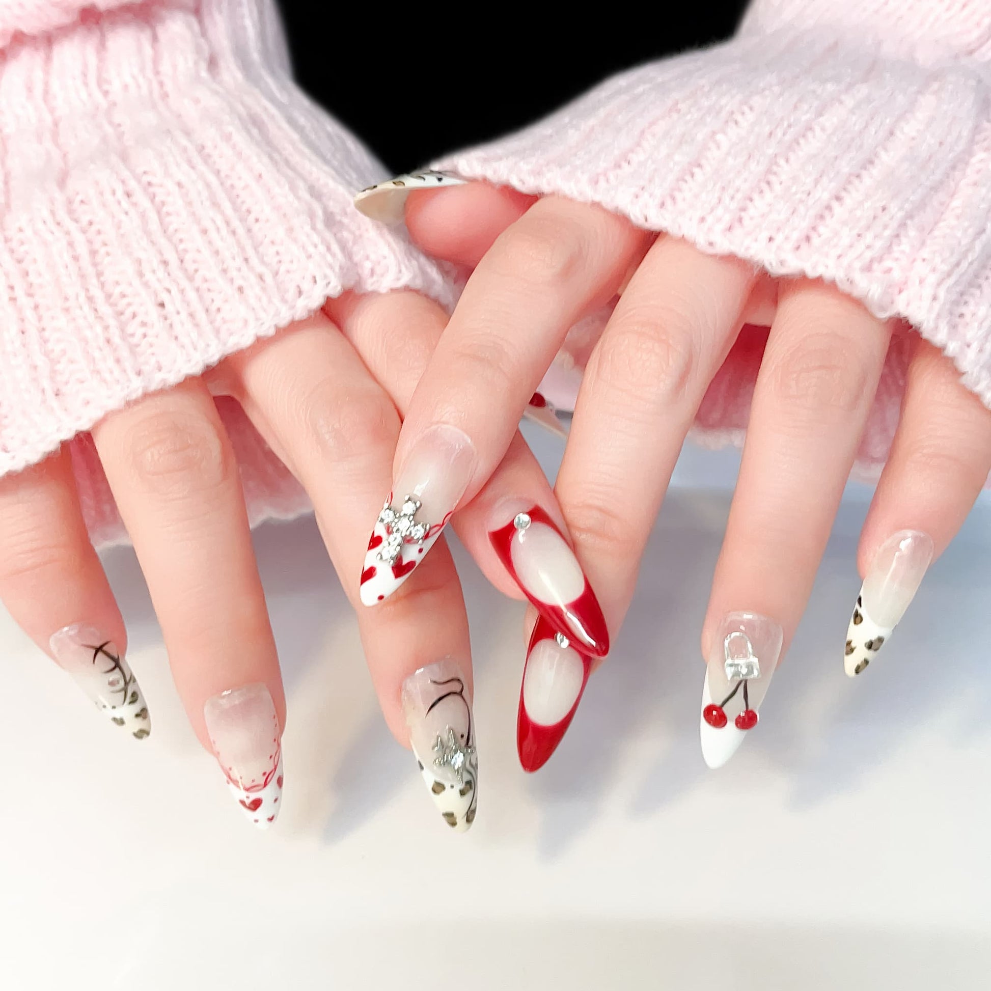 long length red almond press on nails with cherry and animal print design