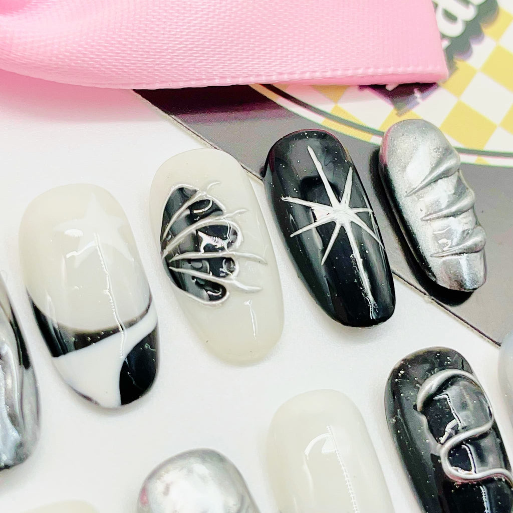 short length silver oval press on nails with metallic wings design