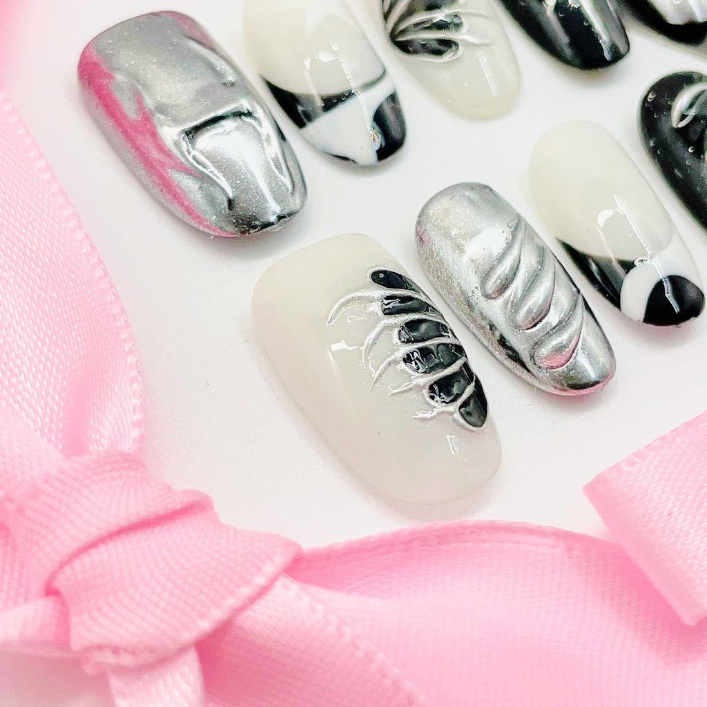short length silver oval press on nails with metallic wings design