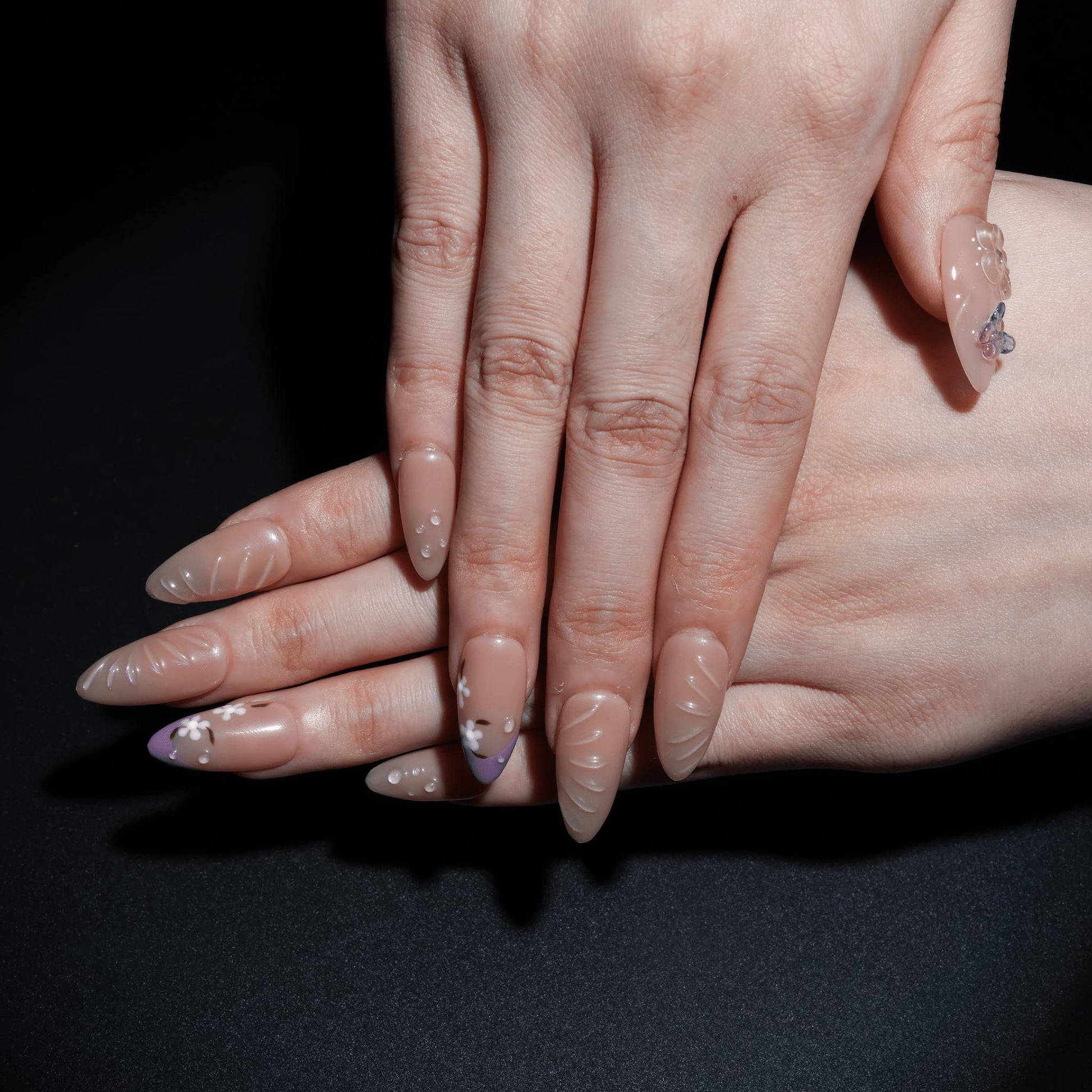 medium length light pink almond press on nails with butterfly charms