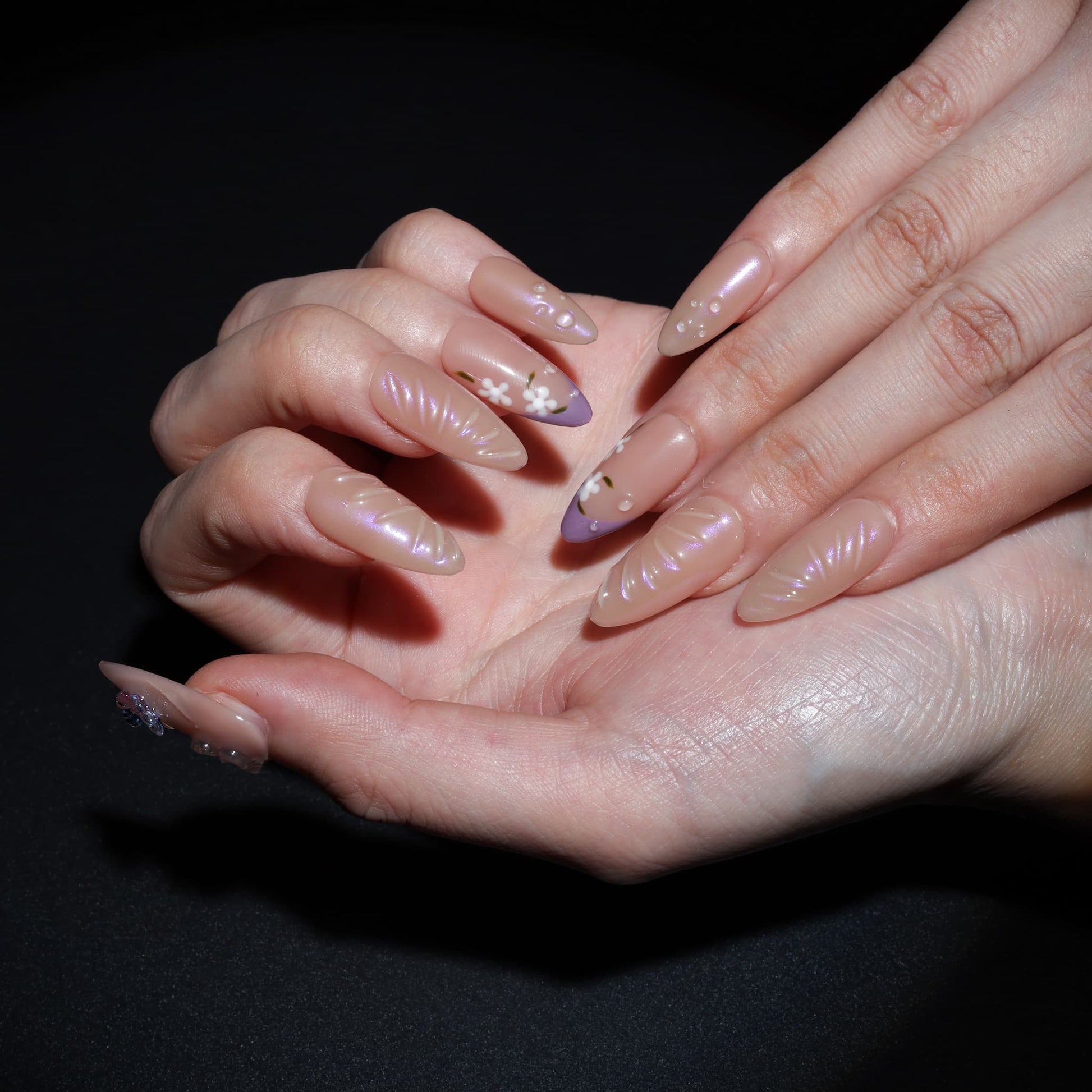 medium length light pink almond press on nails with butterfly charms