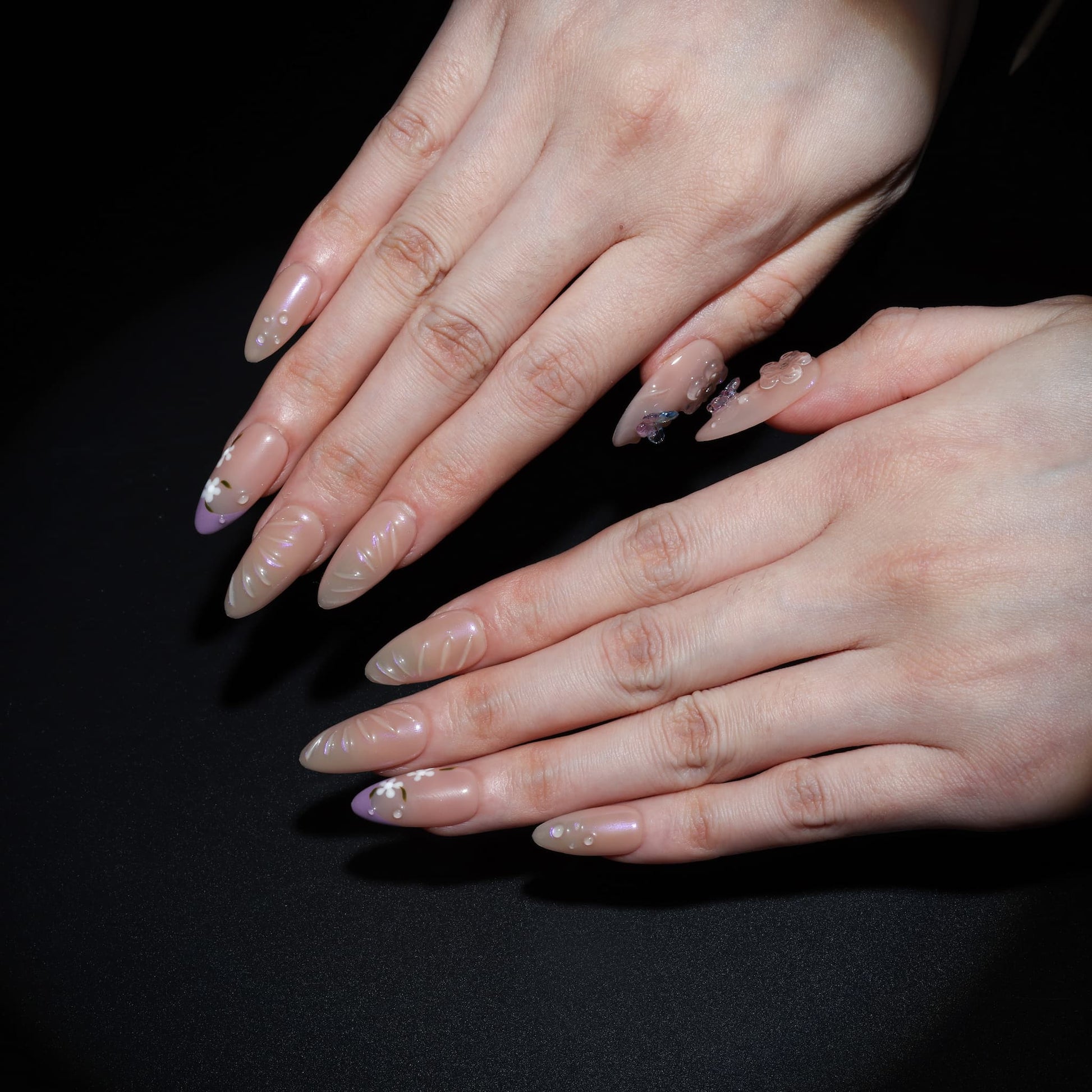 medium length light pink almond press on nails with butterfly charms