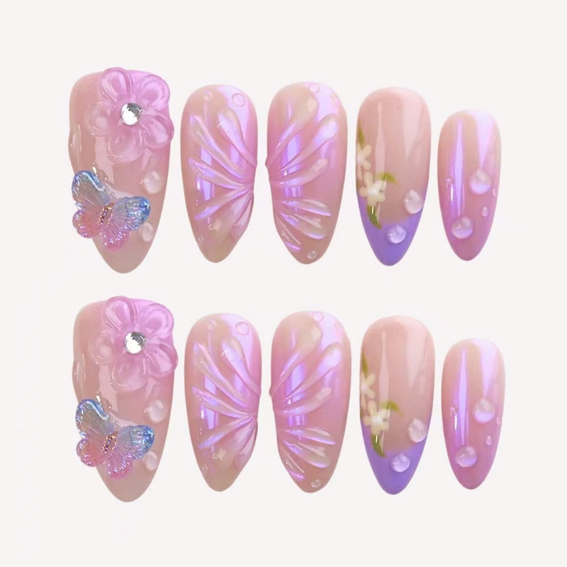 medium length light pink almond press on nails with butterfly charms