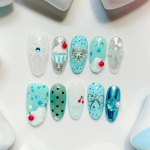 medium length cyan oval press on nails with cherry design