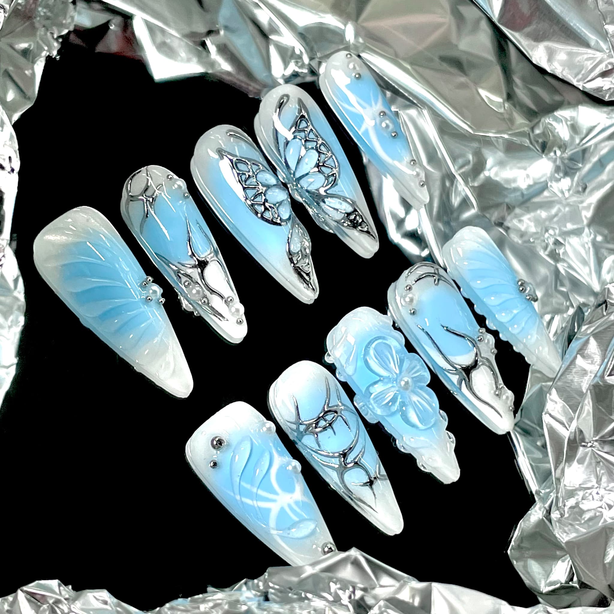 light blue long length stiletto press on nails with butterfly design
