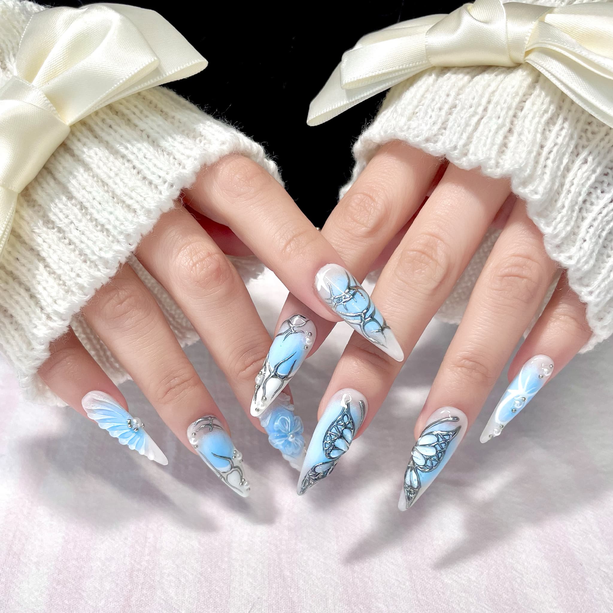 light blue long length stiletto press on nails with butterfly design