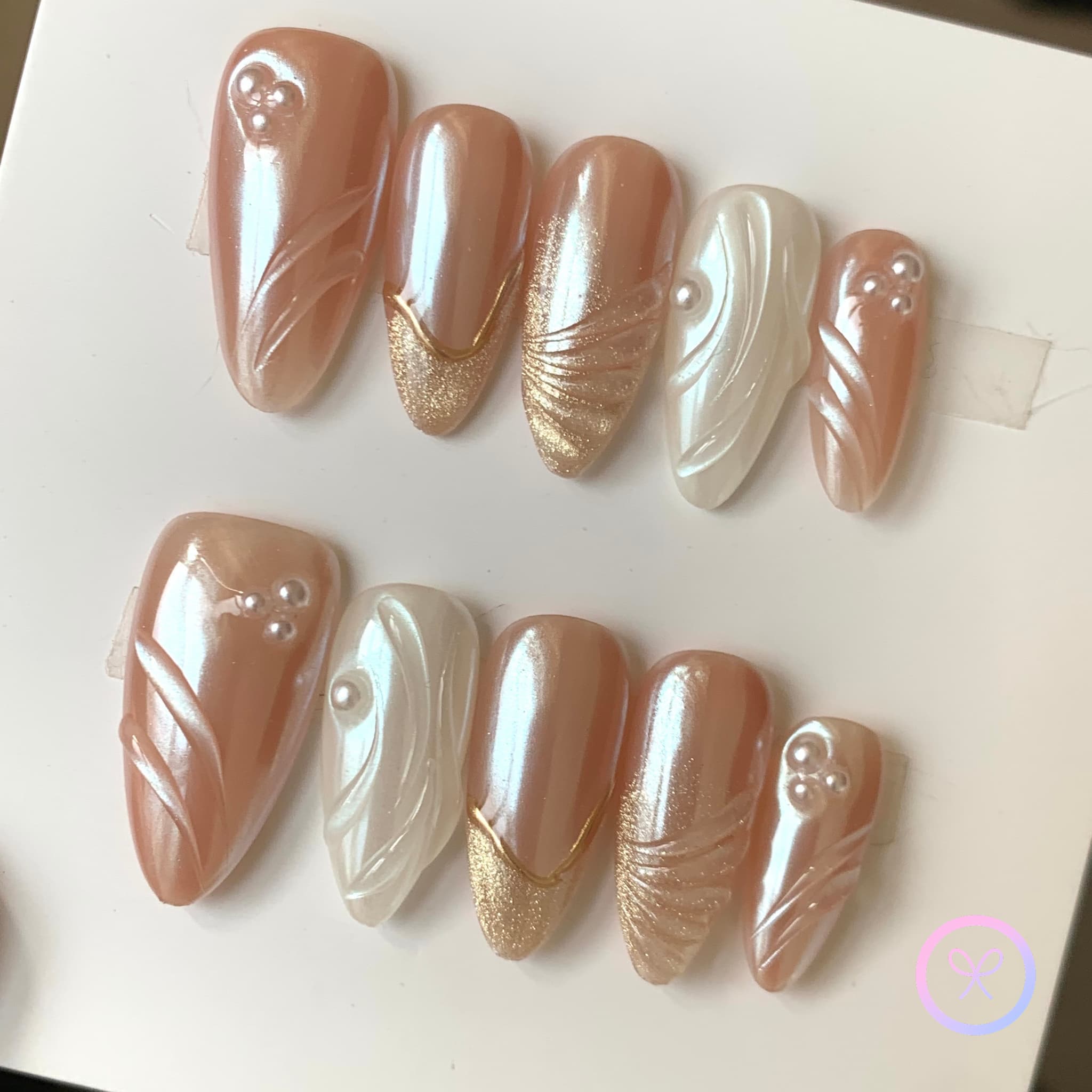 elegant pearlescent nude medium almond press on nails with pearls and cat eyes