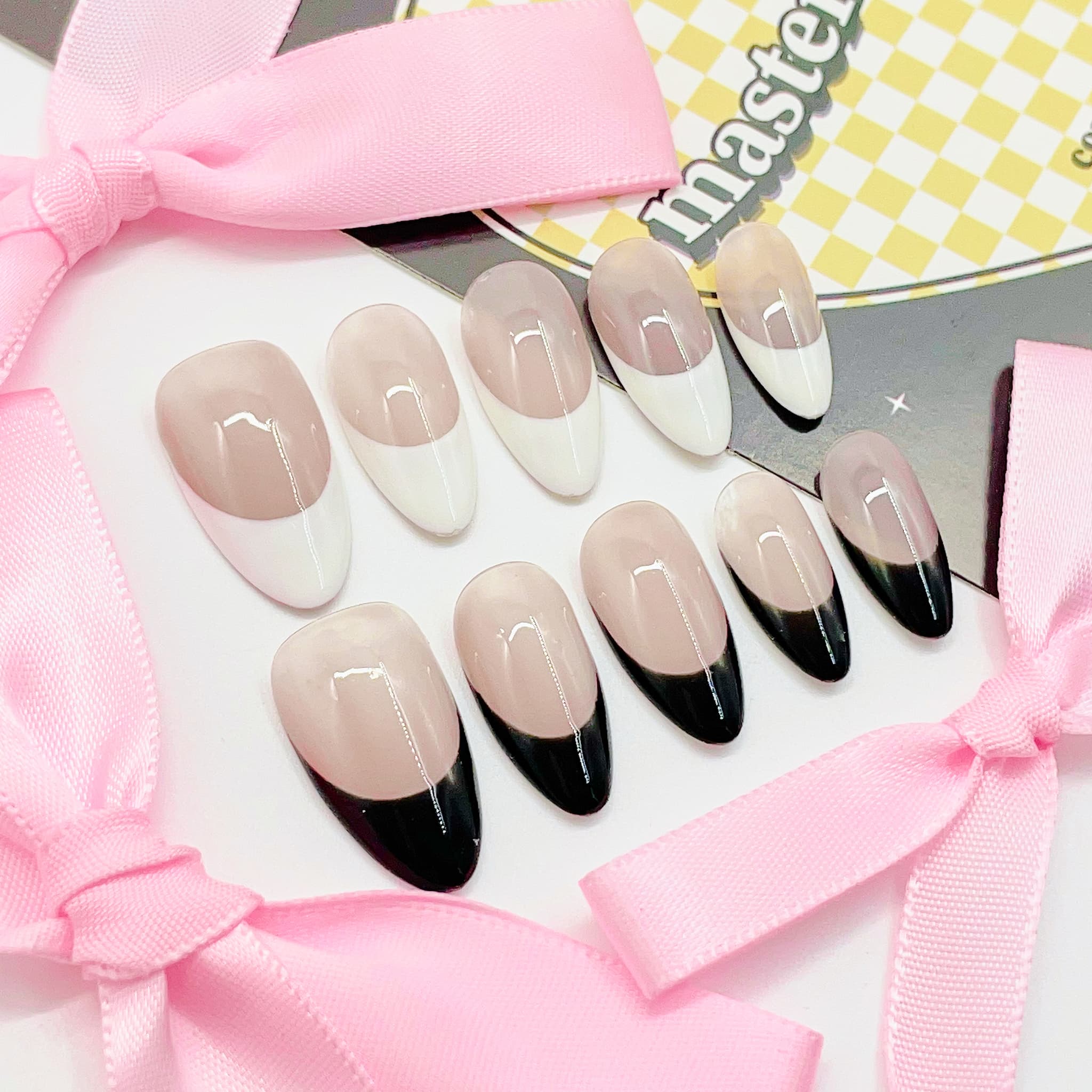 medium length nude almond press on nails with black and white colours french tips