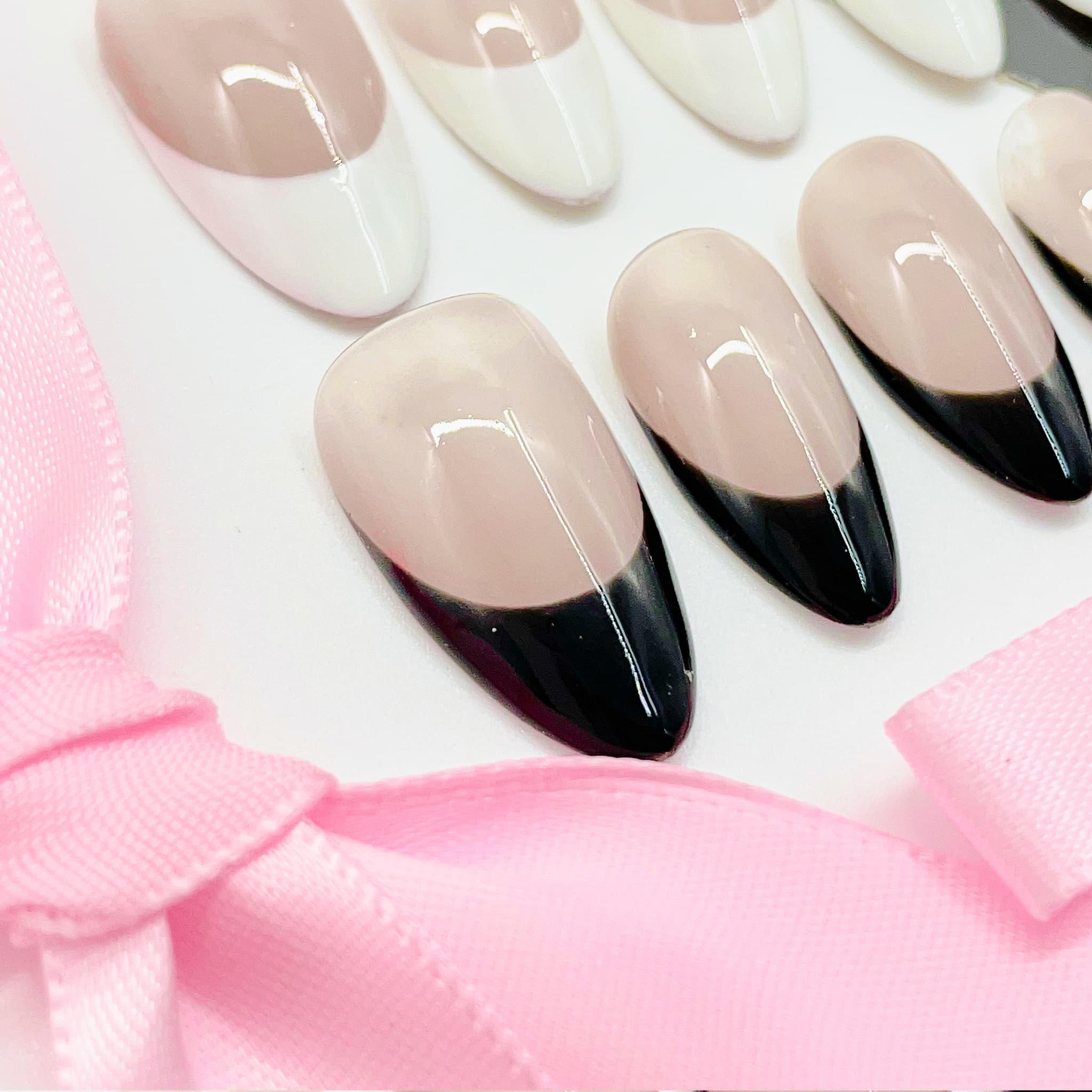 medium length nude almond press on nails with black and white colours french tips