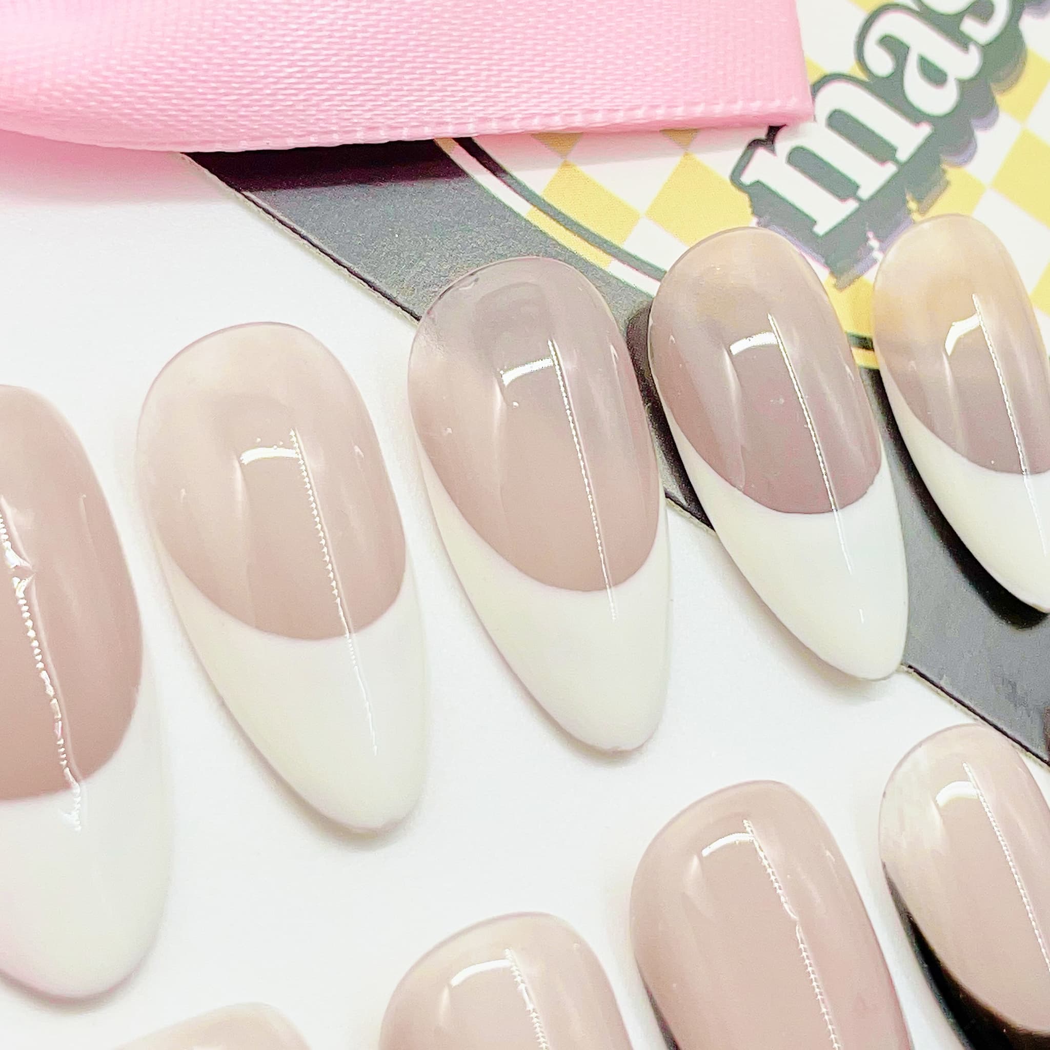 medium length nude almond press on nails with black and white colours french tips