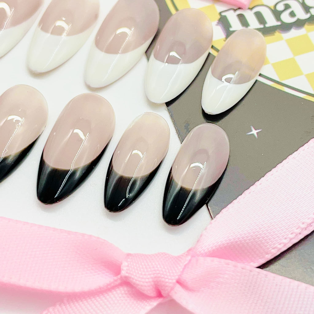 medium length nude almond press on nails with black and white colours french tips