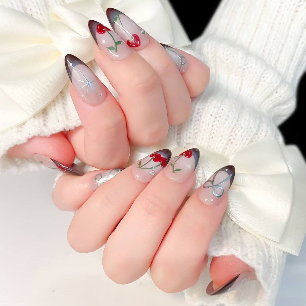 medium length brown almond press on nails with cherry and bow design